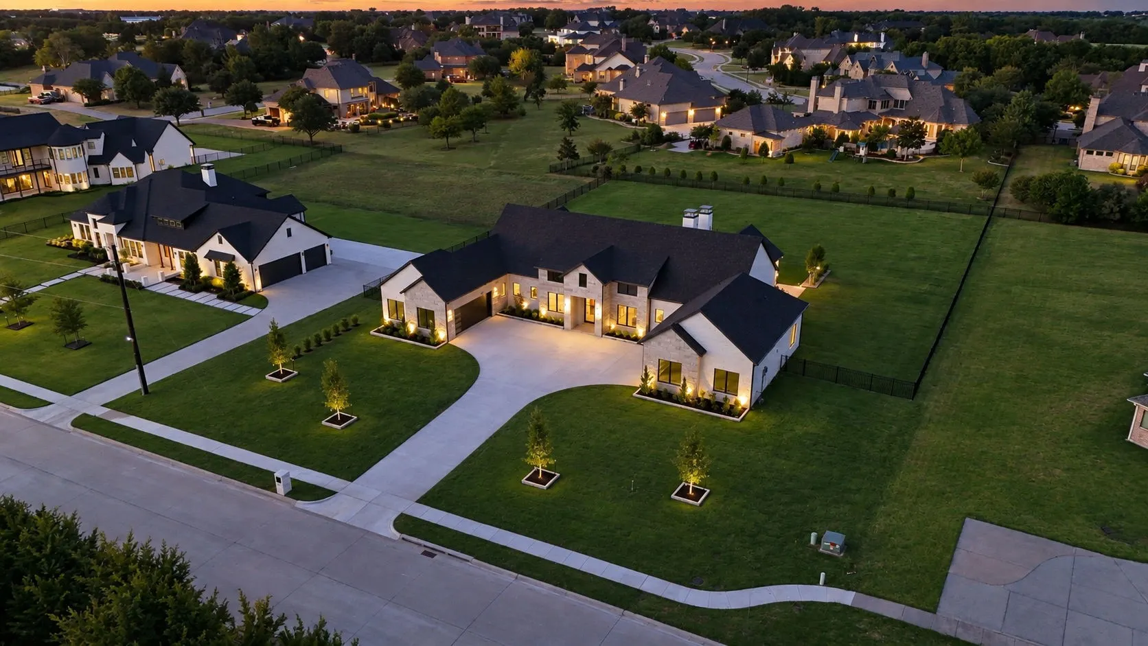 Modern farmhouse exterior with light-toned stone and dark trim accents