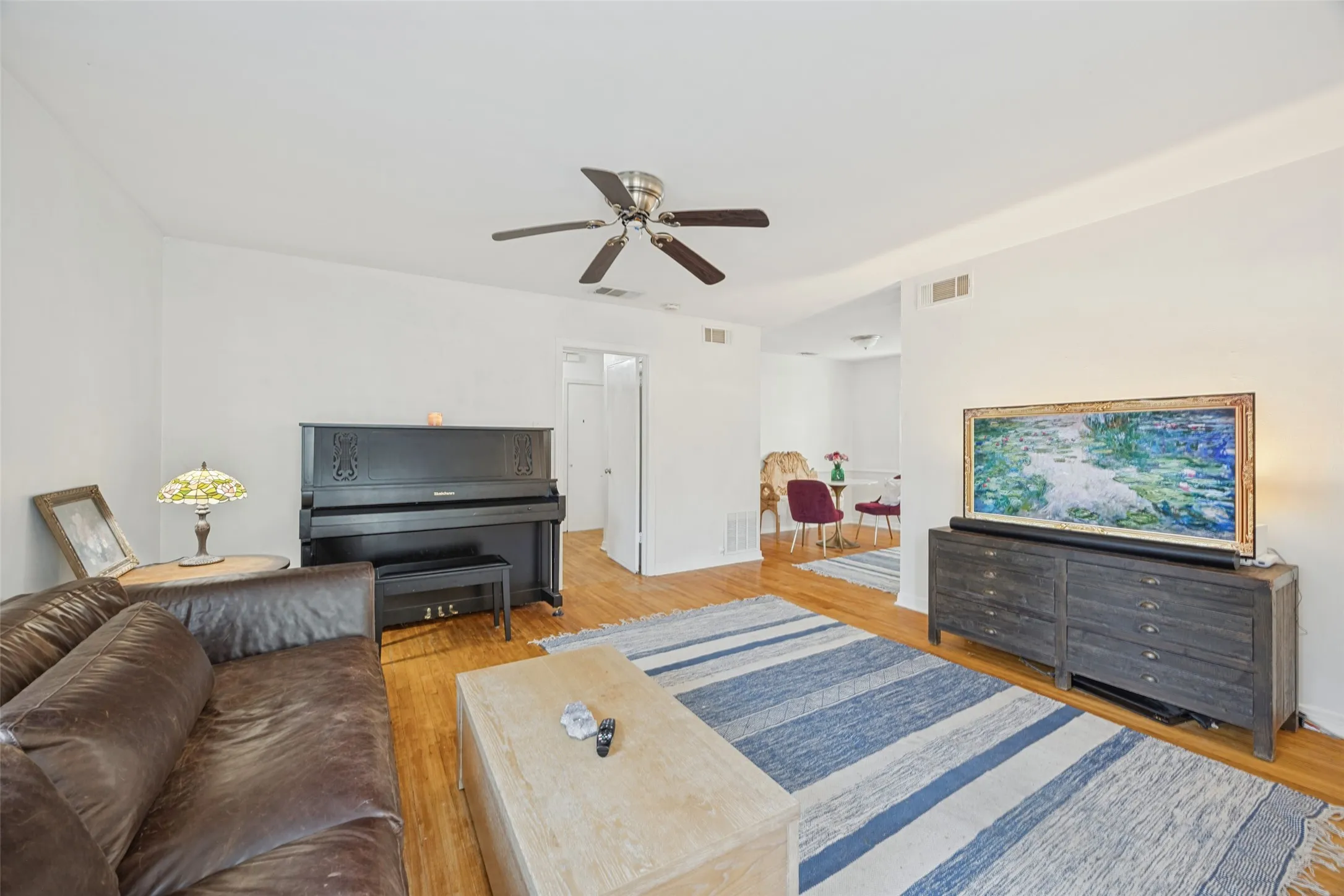 Hardwood flooring throughout, ceiling fan, and fresh paint throughout