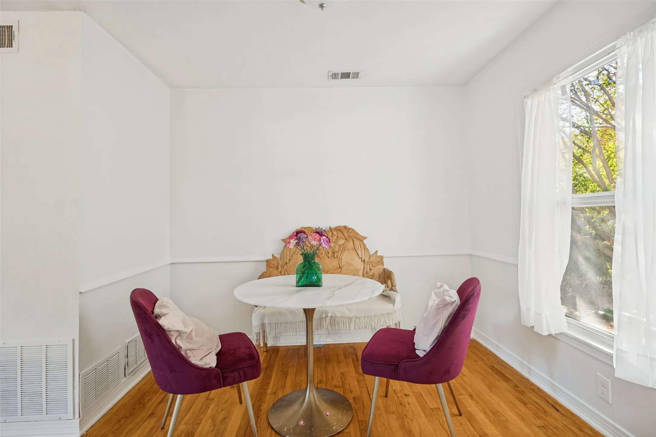 Recessed lighting, hard wood flooring, fresh paint, and a window with natural light