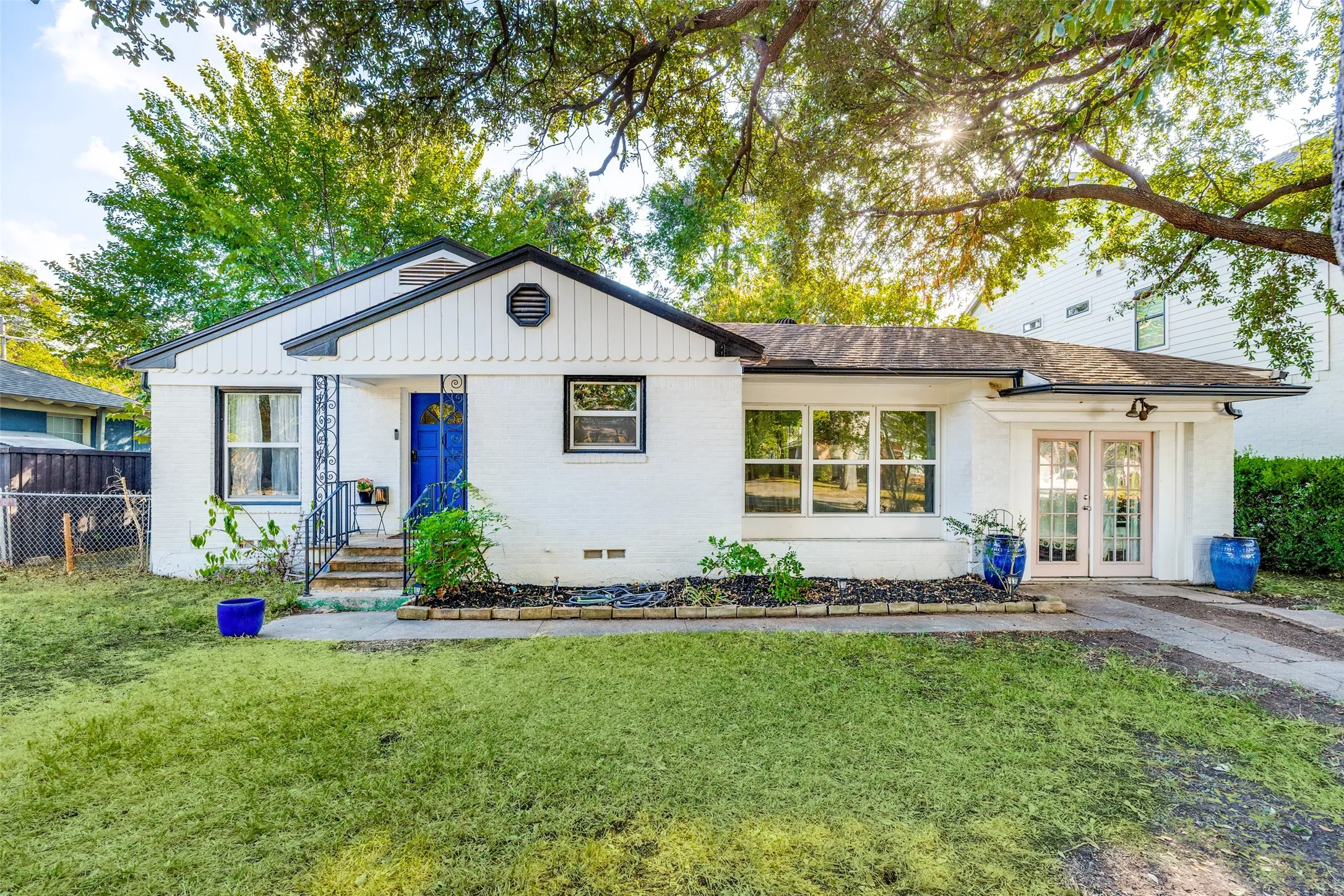 White brick exterior with a distinctive blue entry door