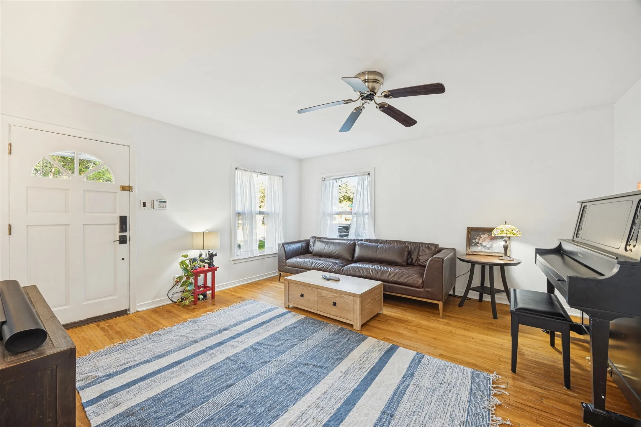 Original hardwood flooring, fresh paint through out,ceiling fan, and multiple windows