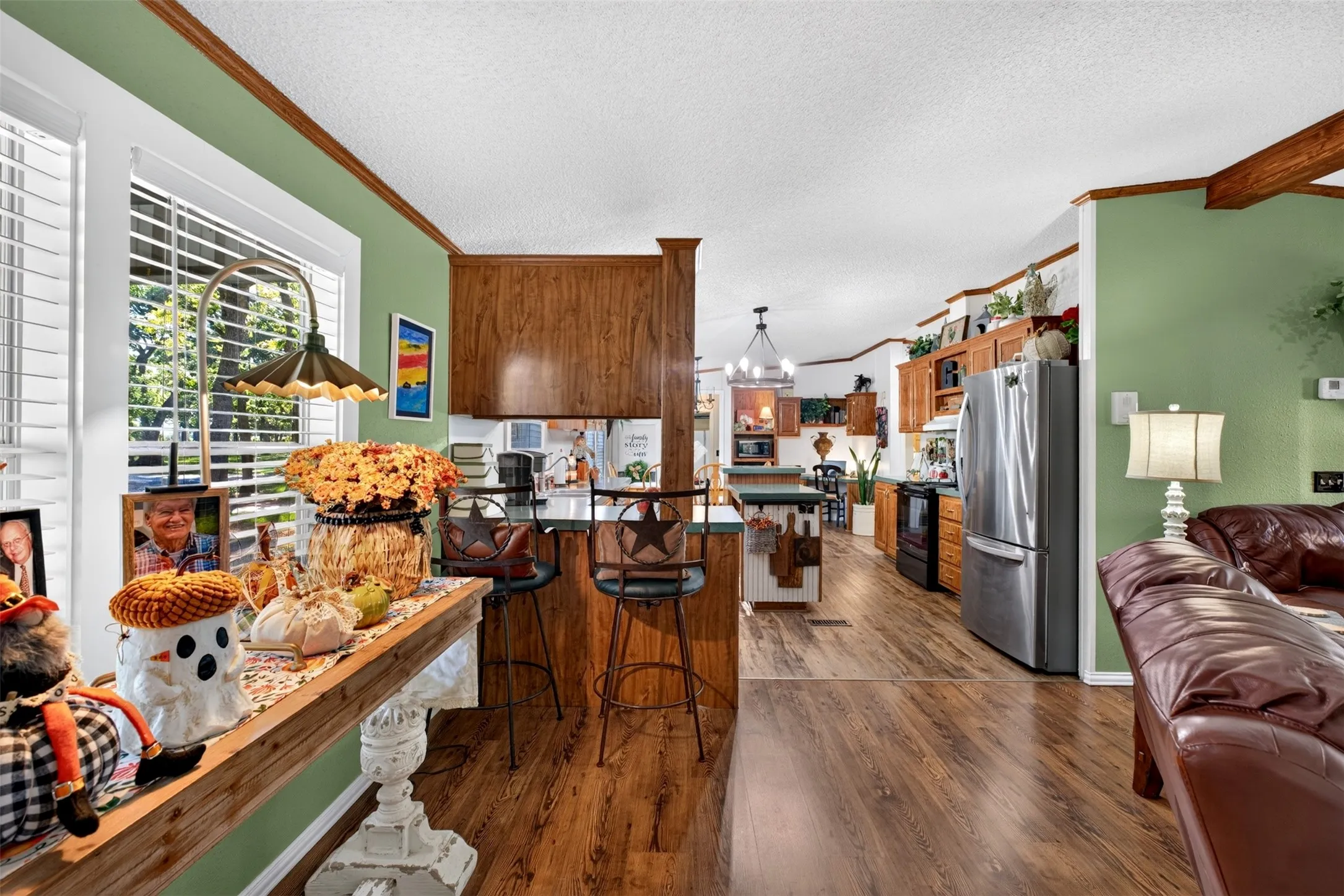 Stainless steel appliances, bar with bar stools, island for additional work space and storage.