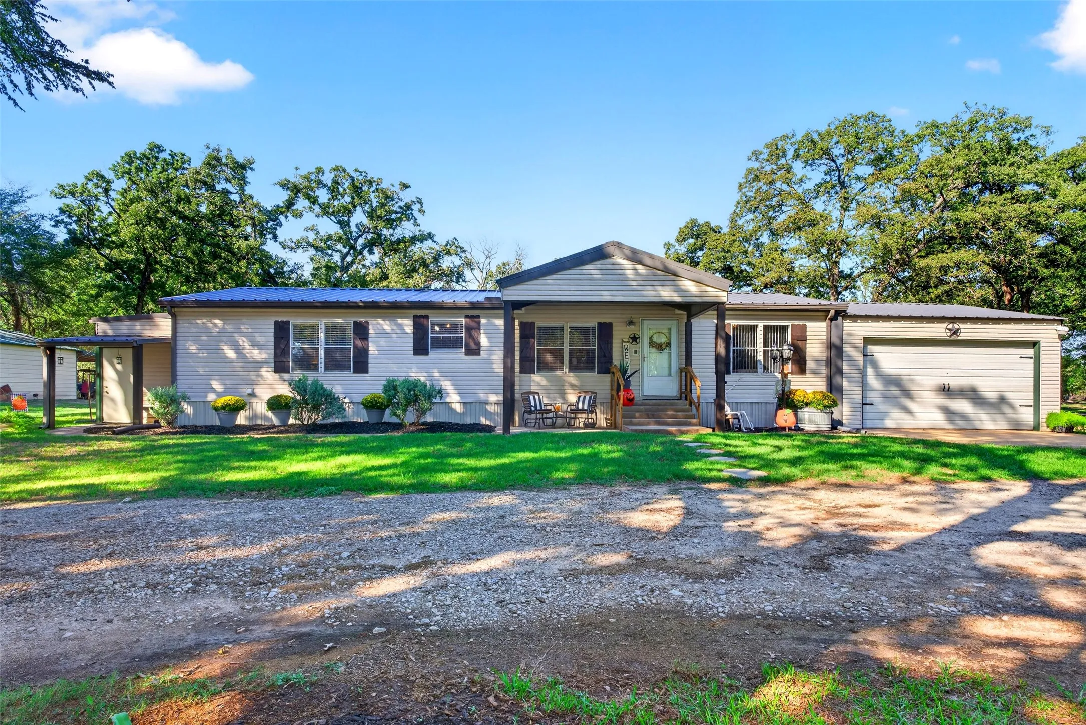 Single-level residence with a metal roof, attached garage and attached storage or office on opposite end