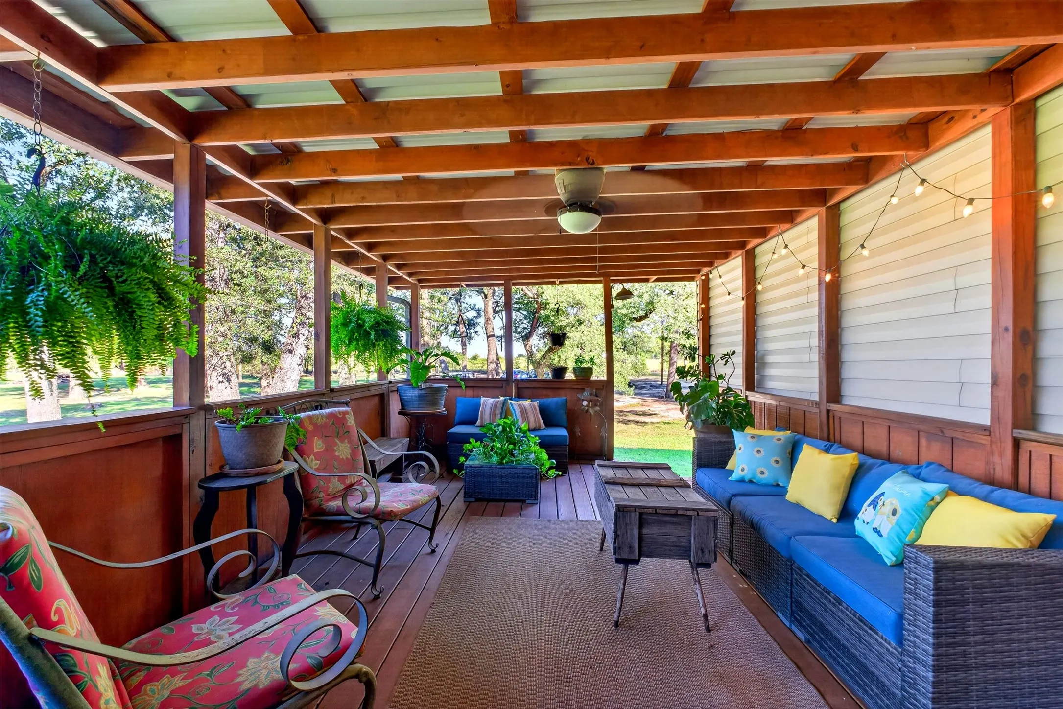 Unscreened side of back porch with ceiling fan and amazing view of pond