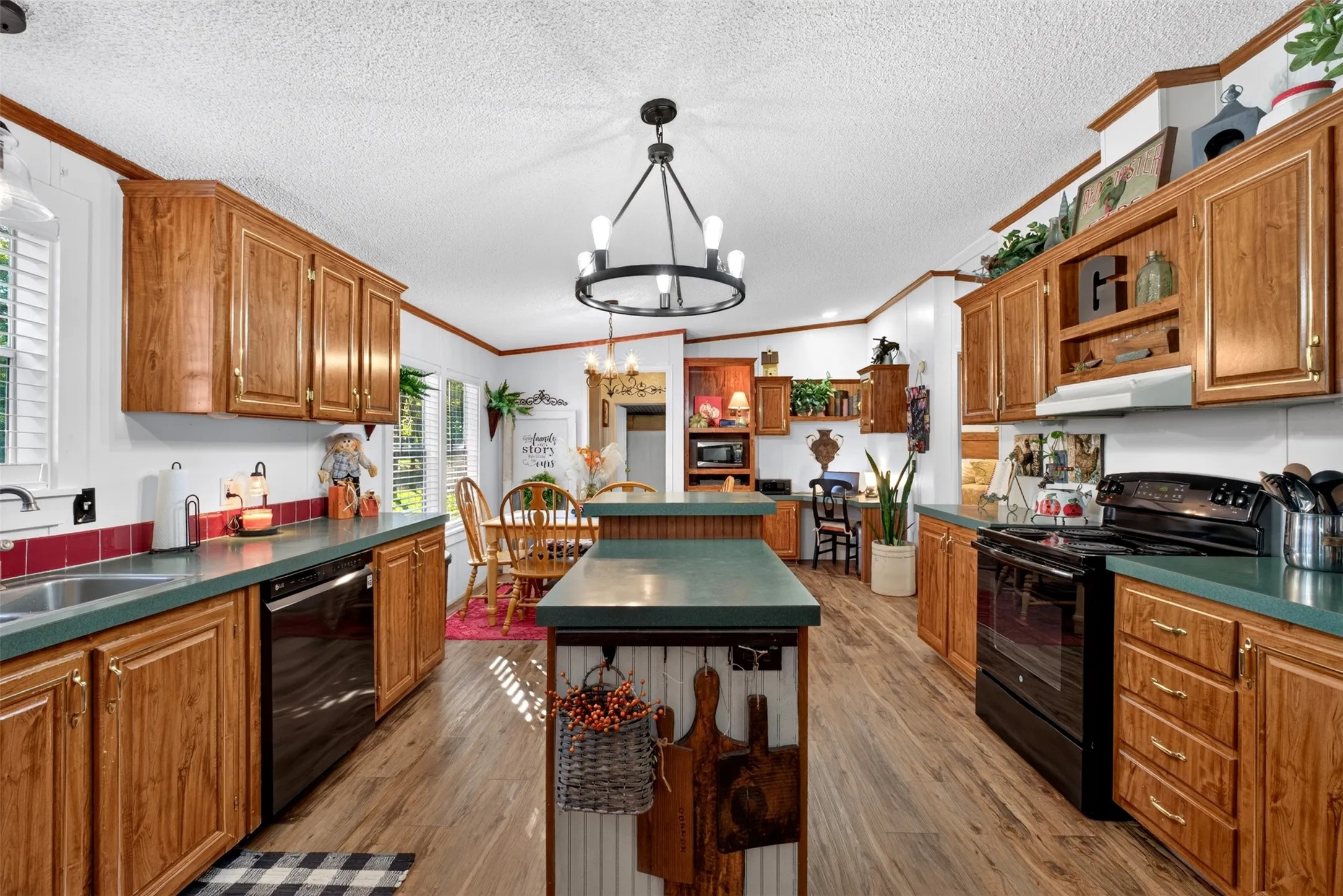 Designer light fixture, tall wood cabinets and lots of natural light.