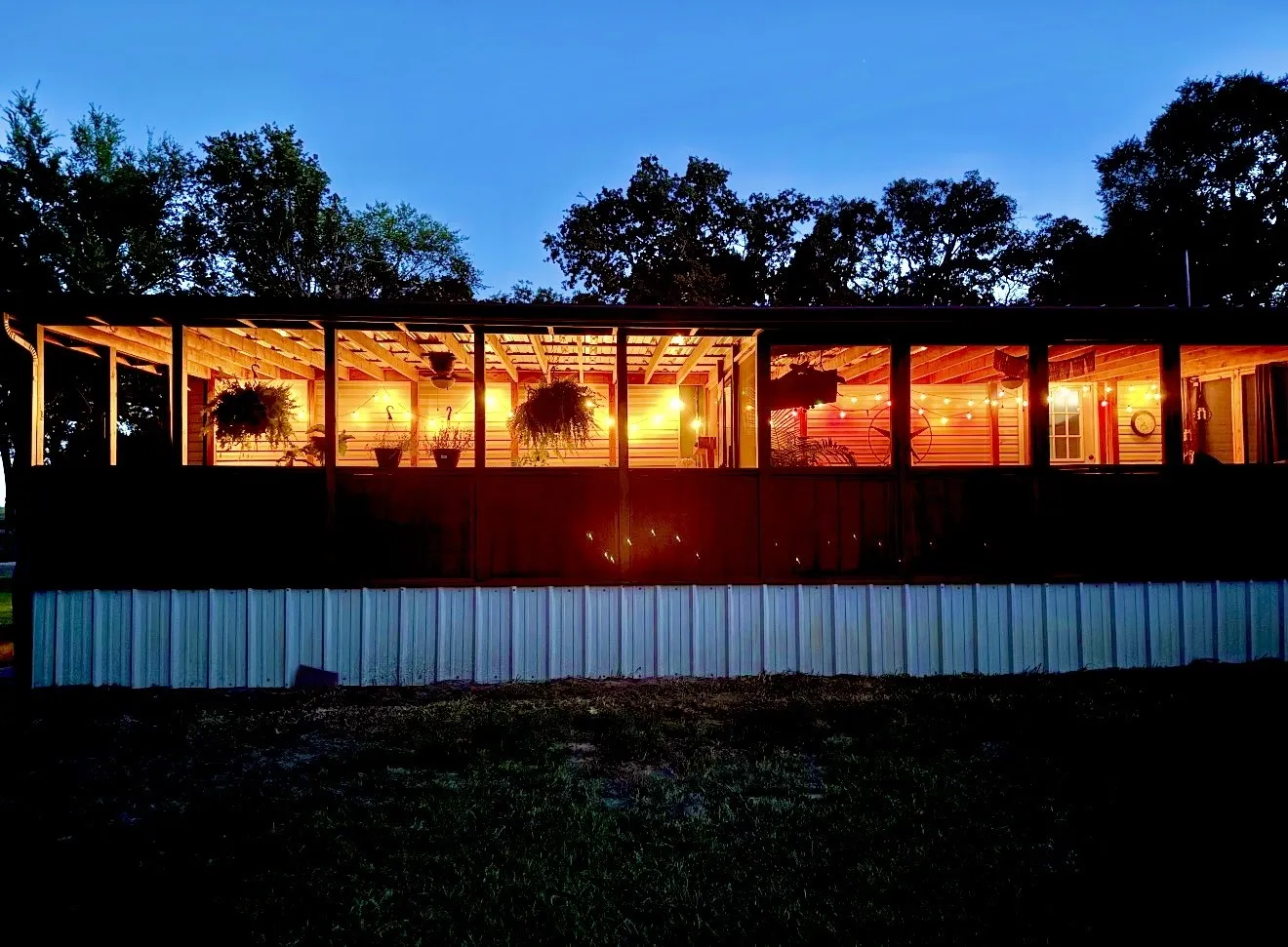 Well-lit back porch that looks out onto the acre long pond.  Home extends longer to the right as seen in the next photo