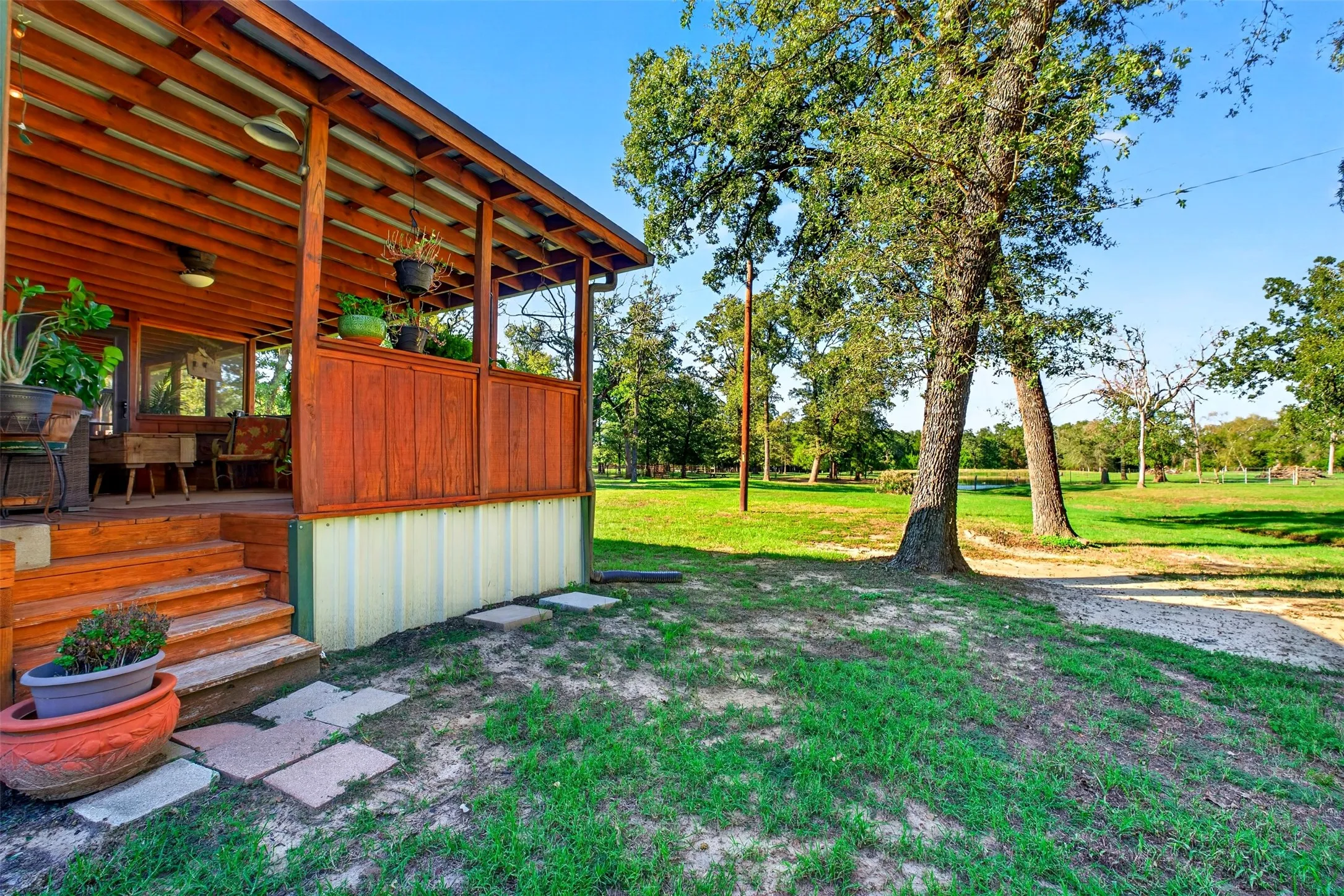 Covered back porch with ceiling fans and exterior entrance