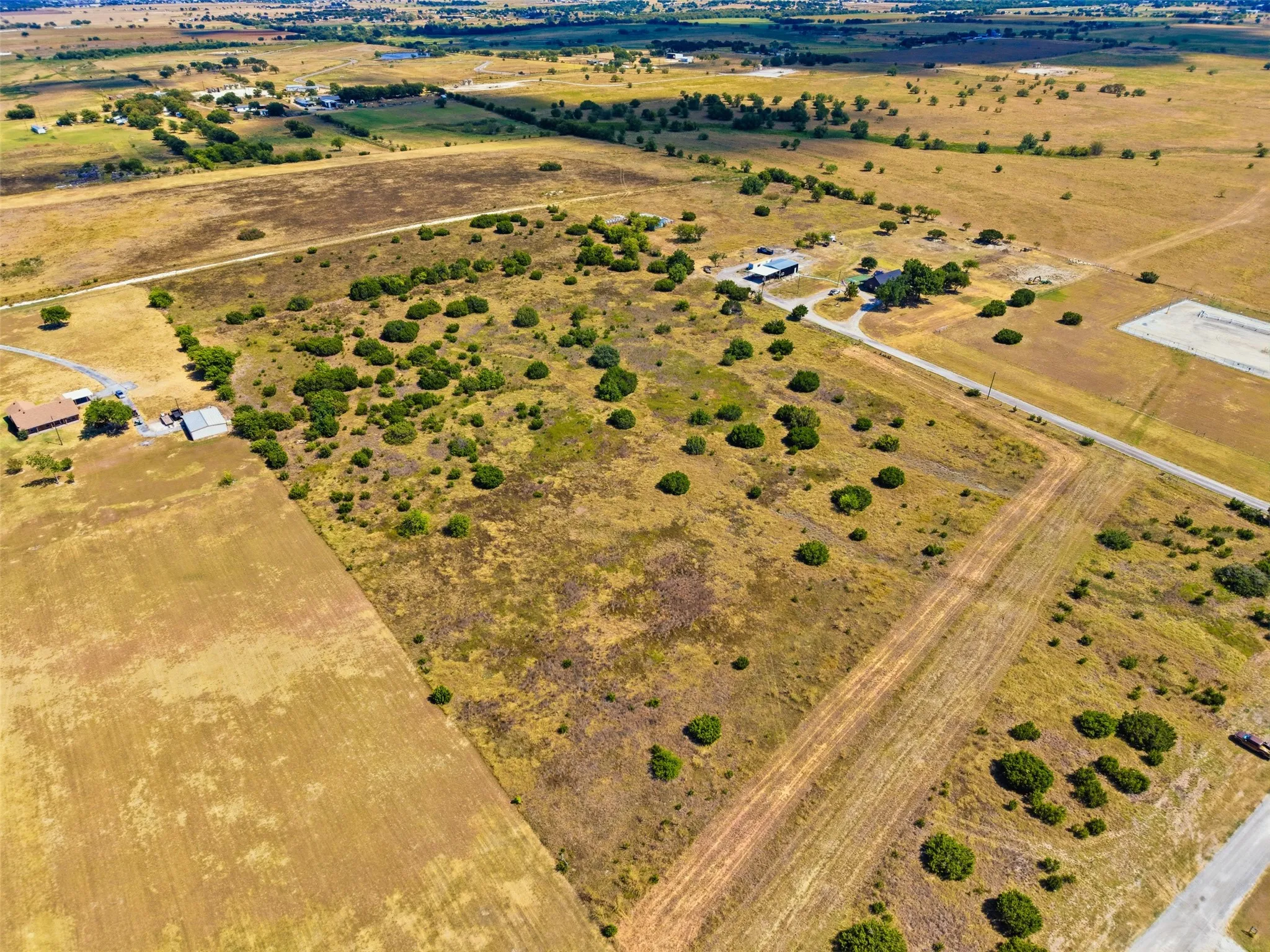 Expansive undeveloped land with natural vegetation and scattered trees