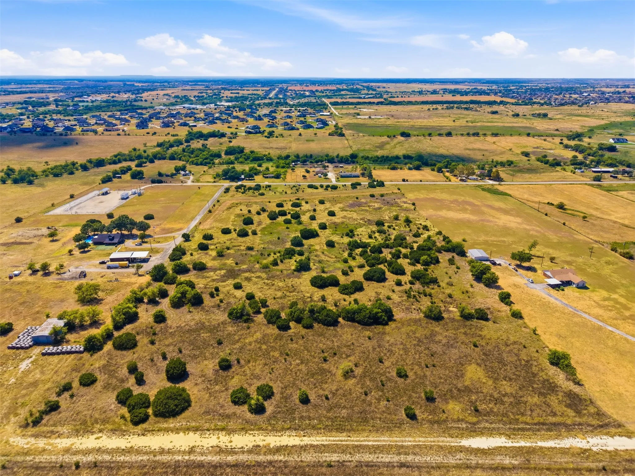 Expansive open land with scattered natural foliage
