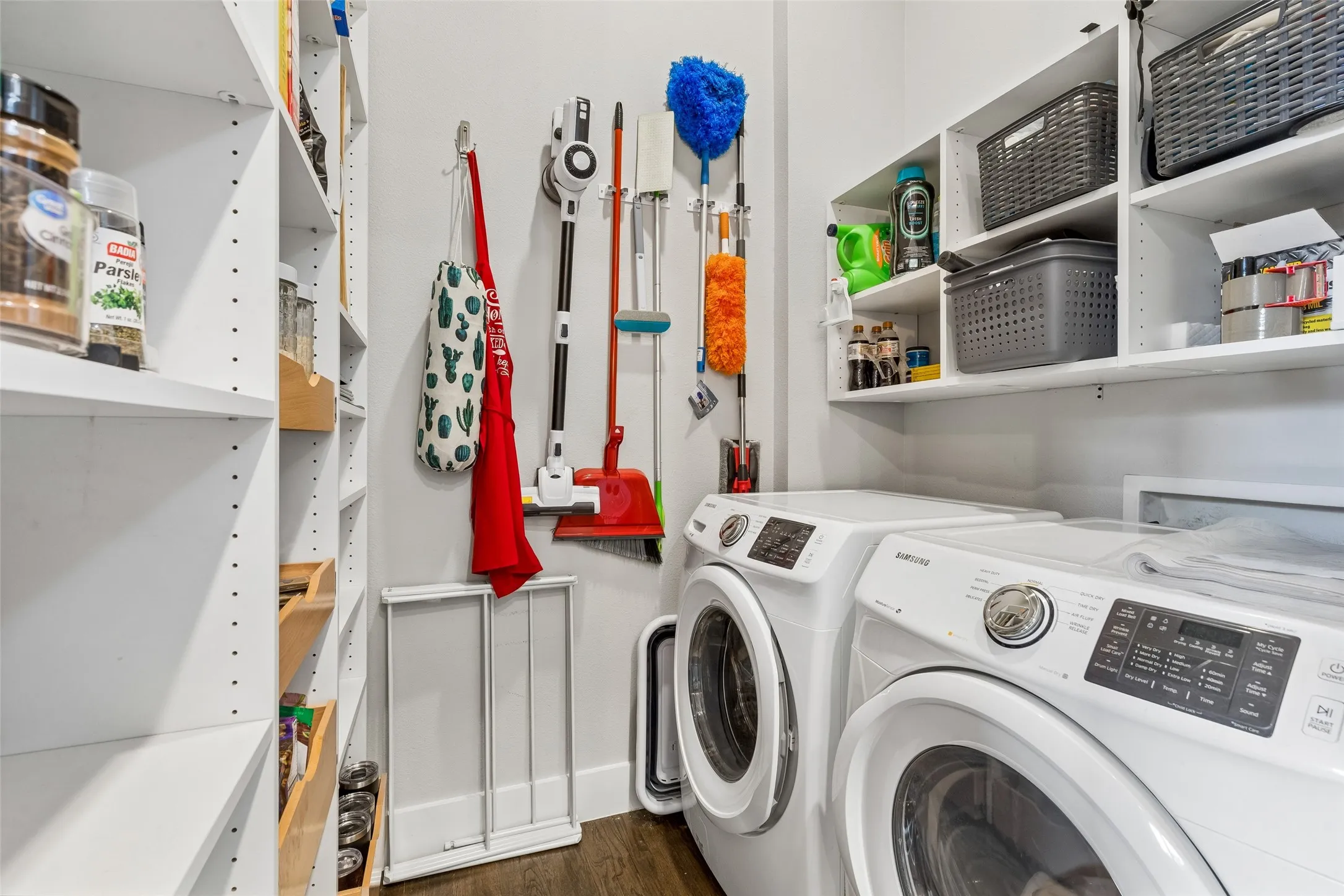 Integrated laundry area featuring built-in shelving.