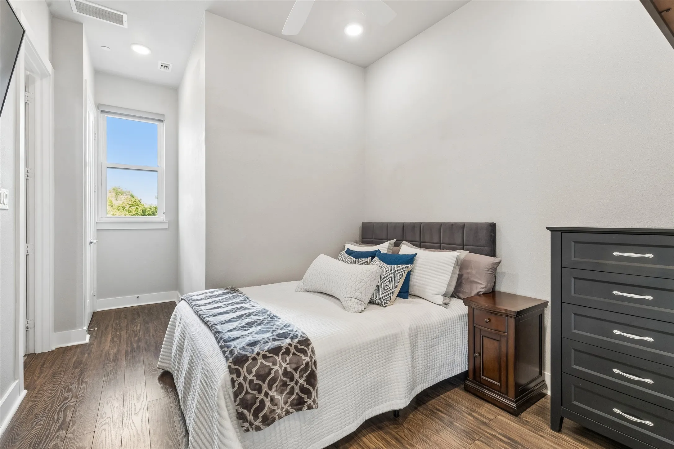 Wood-finish flooring, recessed lighting, and a ceiling fan