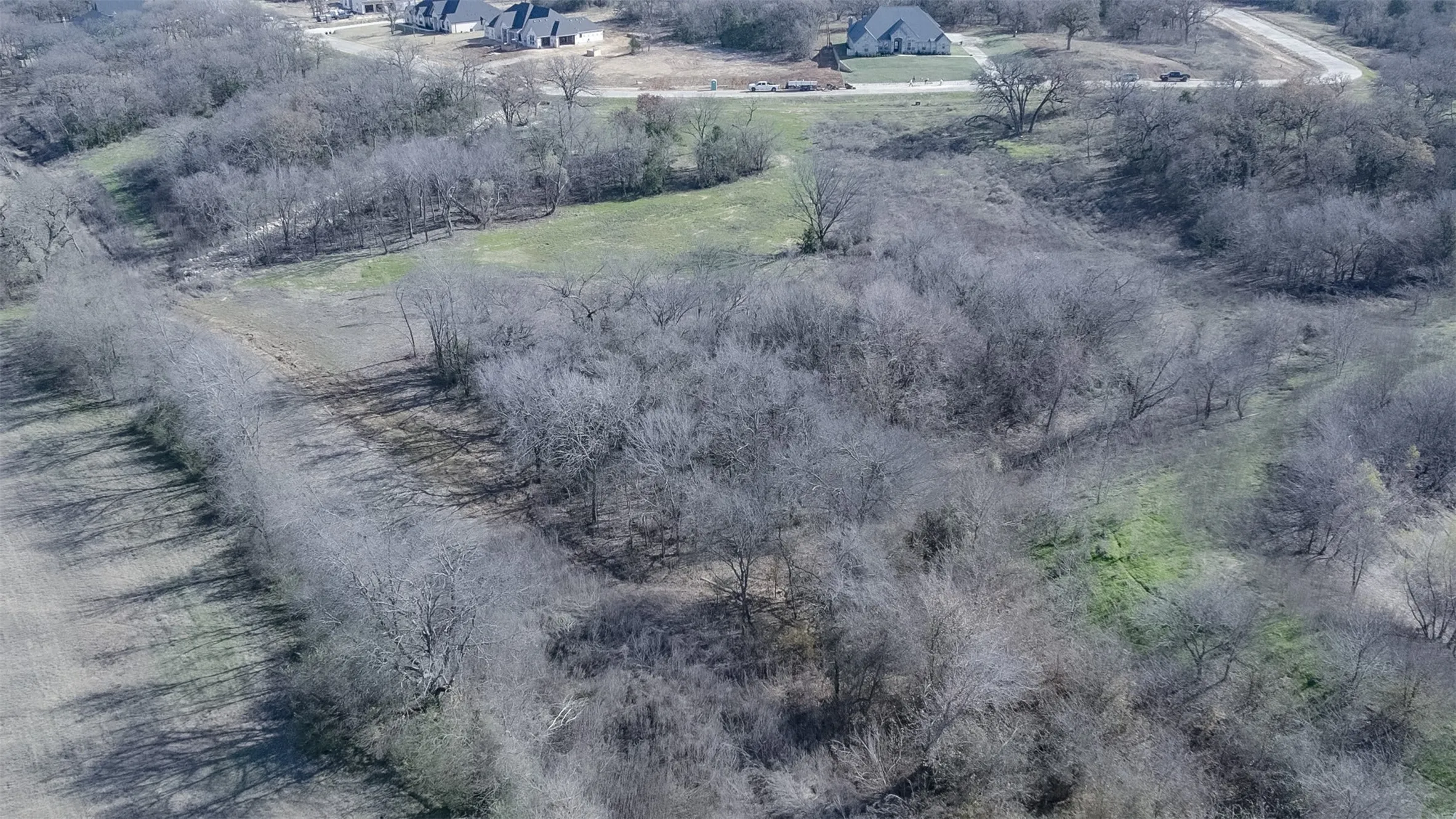 Expansive undeveloped land featuring natural foliage and open grassy areas