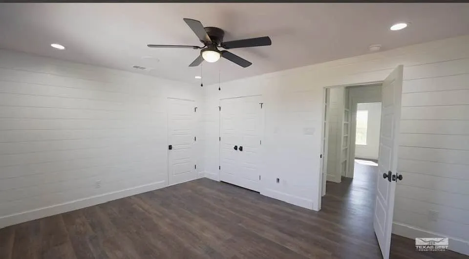 Upstairs, two more bedrooms each get a private walk-in closet and extra attic-accessed storage, sharing a full bath with a dual-sink vanity.