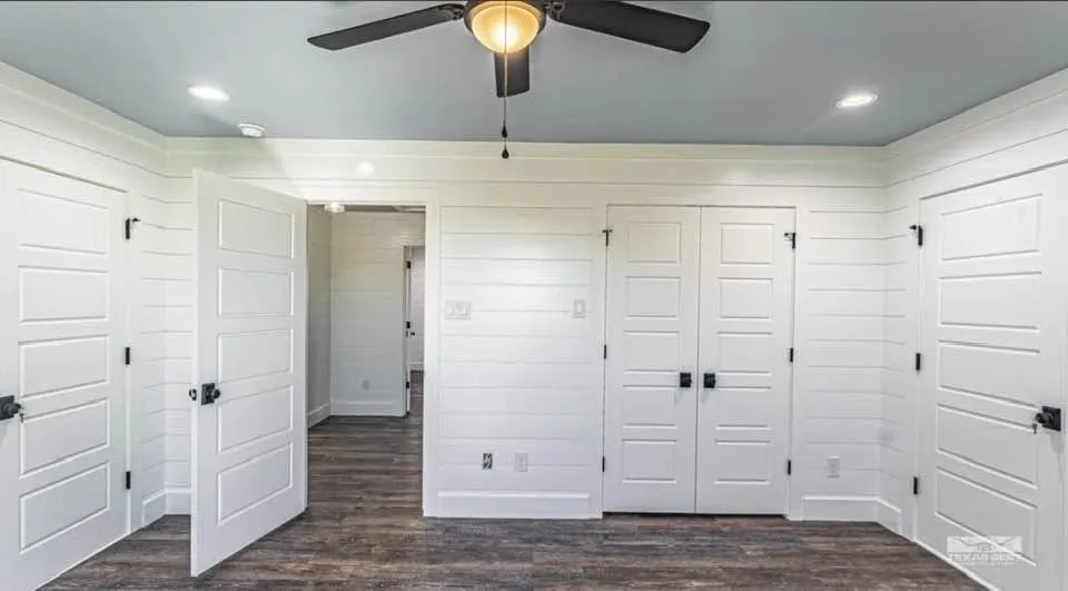 Upstairs, two more bedrooms each get a private walk-in closet and extra attic-accessed storage, sharing a full bath with a dual-sink vanity.