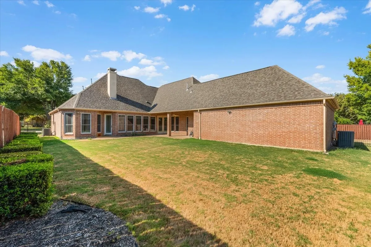 Brick exterior with a gabled roof and a rear patio