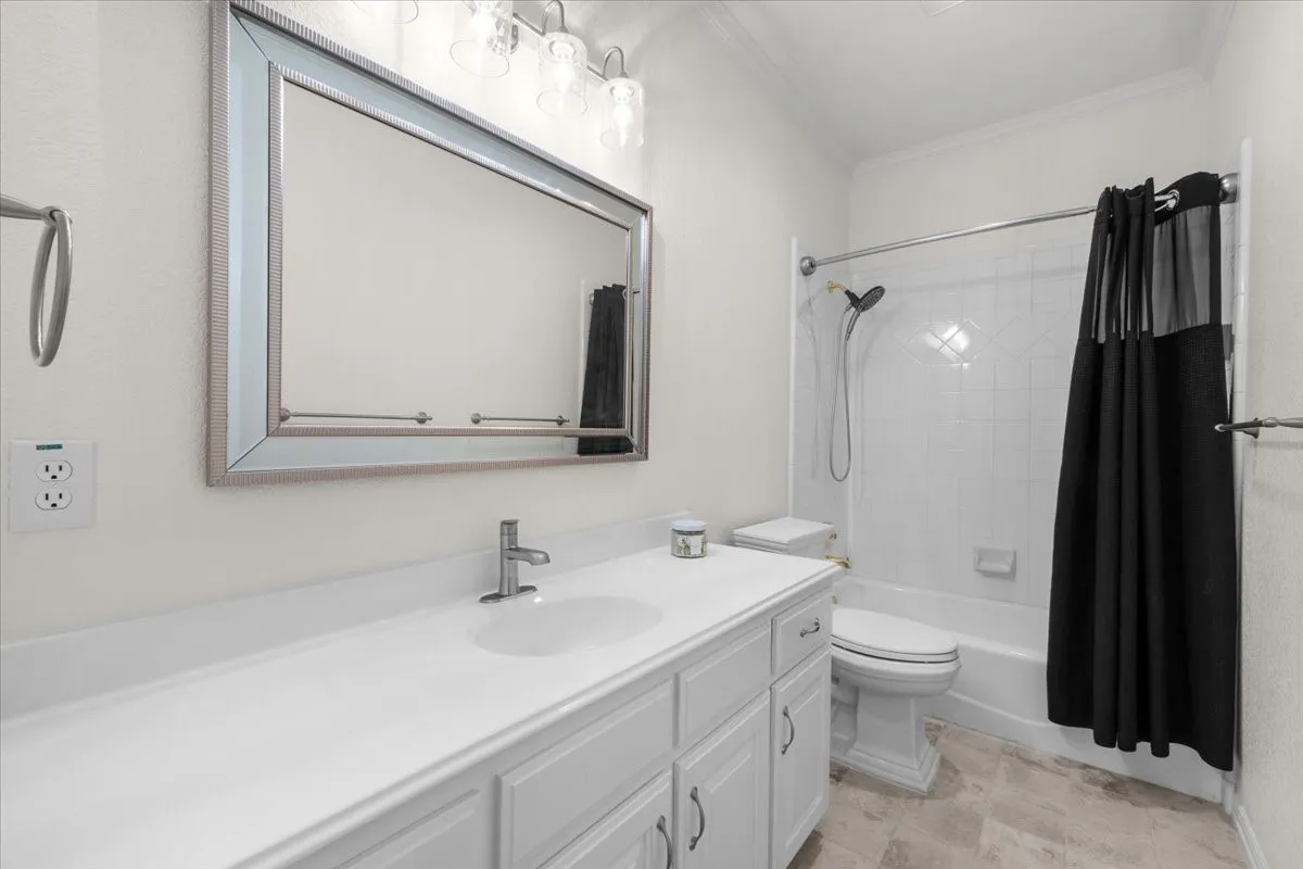 White vanity with under-sink storage, integrated basin, and chrome faucet