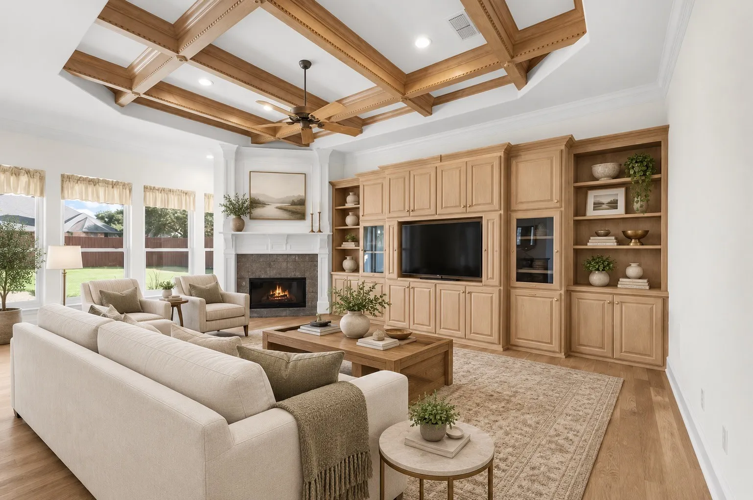 Tray ceiling with exposed wood beams, built-in entertainment center with shelving, wood-finish flooring, and a fireplace with a stone surround AI staged