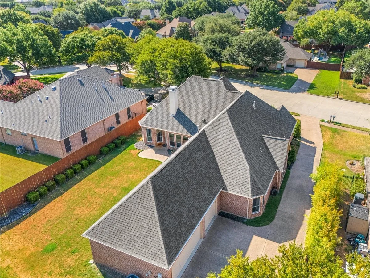Brick exterior with multiple gables and a multi-car driveway