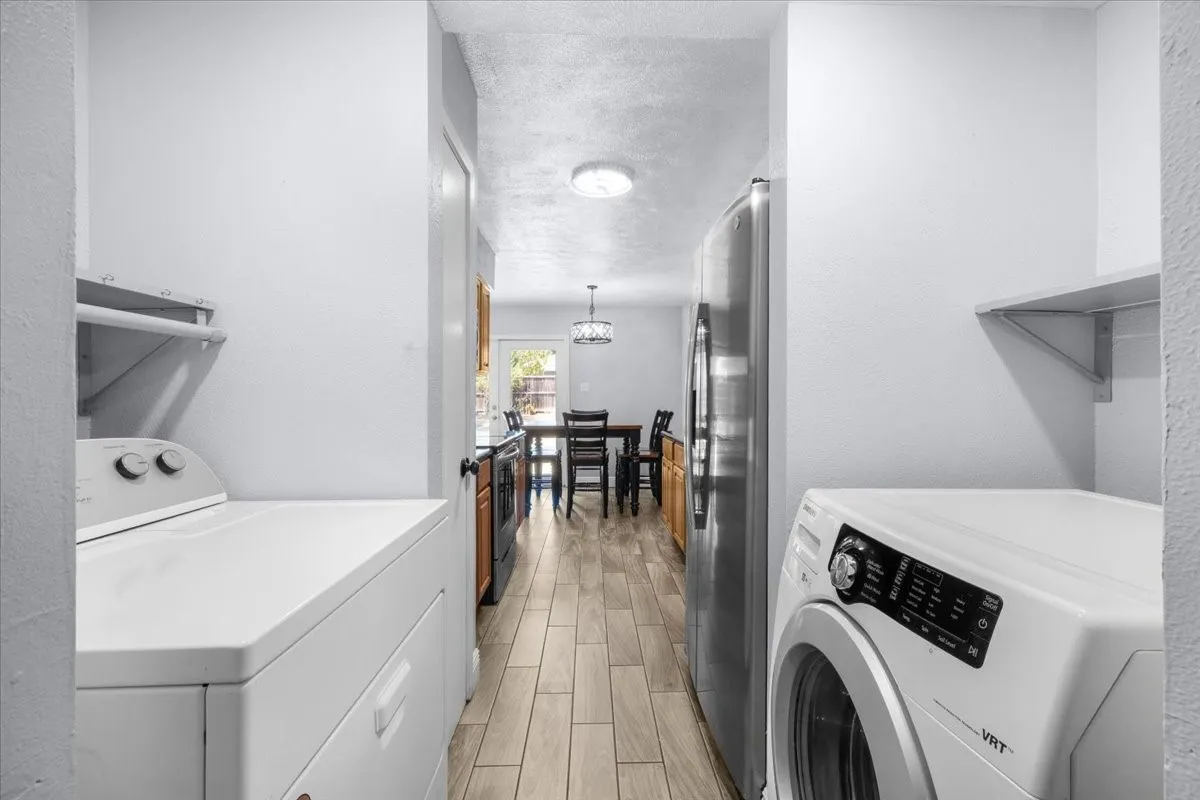 Laundry space featuring built-in shelving, tile flooring, and a flush-mount ceiling light