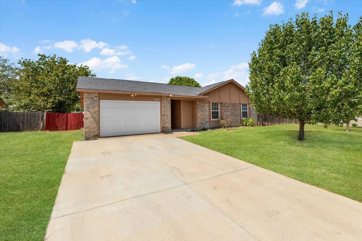 Concrete driveway leading to a two-car garage