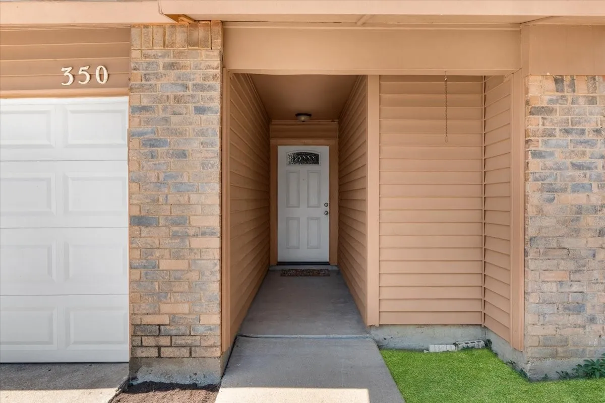 Brick and siding exterior featuring a covered entryway