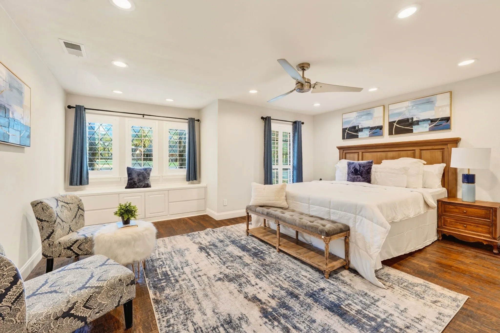 Hardwood flooring, recessed lighting, ceiling fan, built-in window seating, and built-in storage drawers