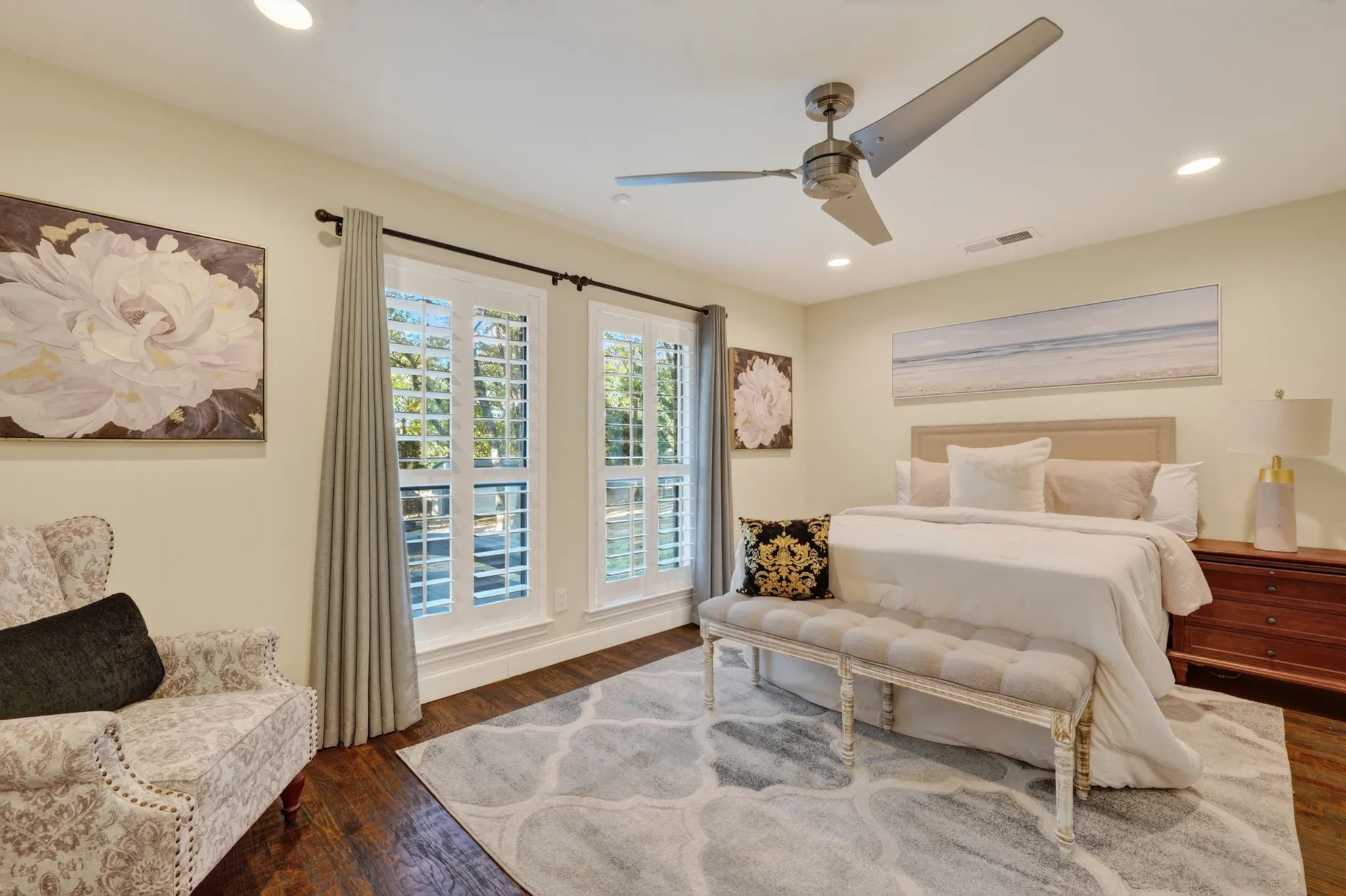 Downstairs Guest bedroom with Recessed lighting, ceiling fan, wood flooring, plantation shutters
