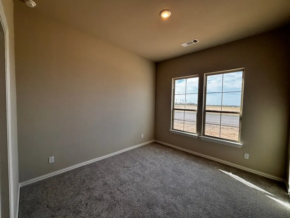 Neutral wall paint, plush carpeting, dual pane windows, and a recessed ceiling light