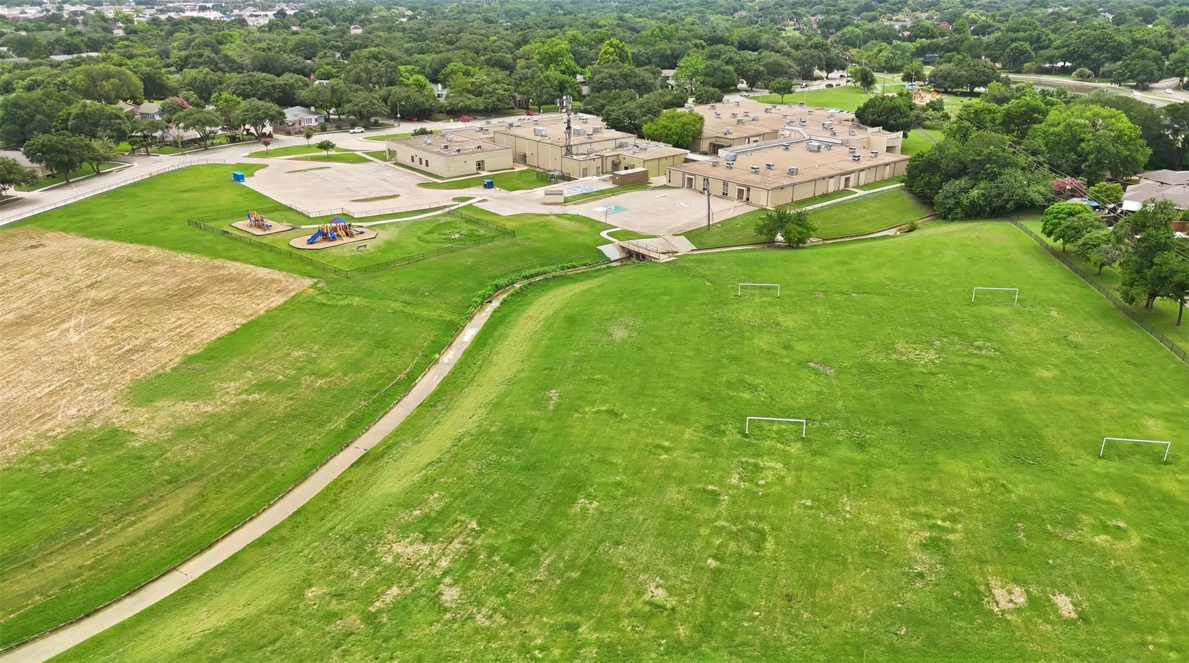 Expansive green space featuring multiple soccer goals