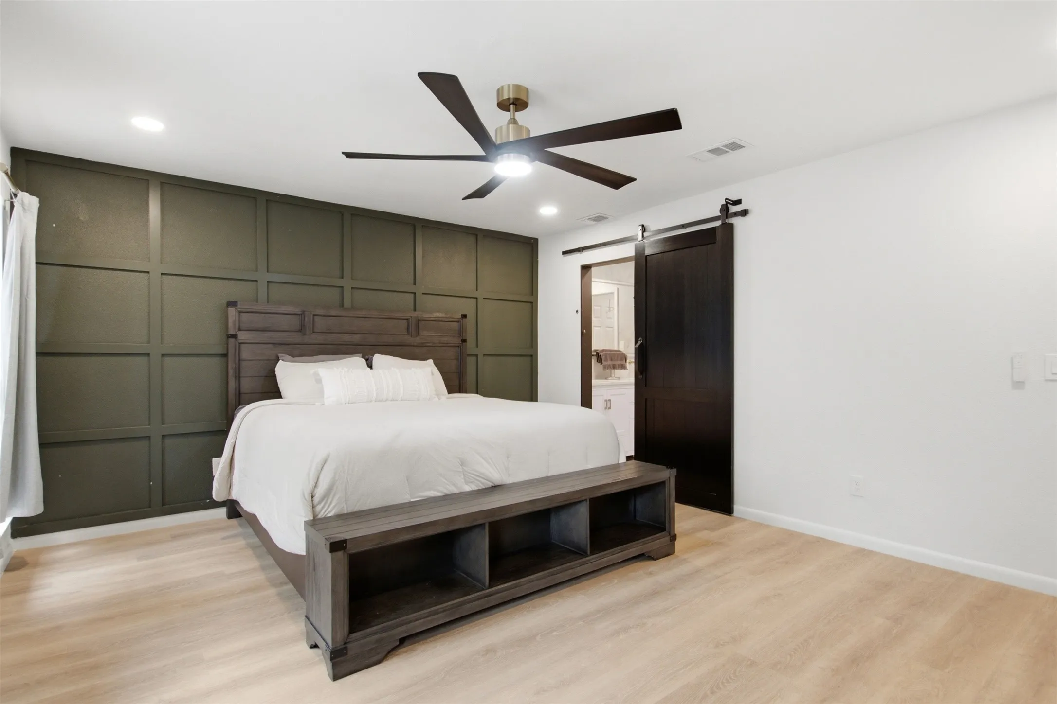 Bedroom featuring a dark green grid accent wall, recessed lighting, and a modern ceiling fan