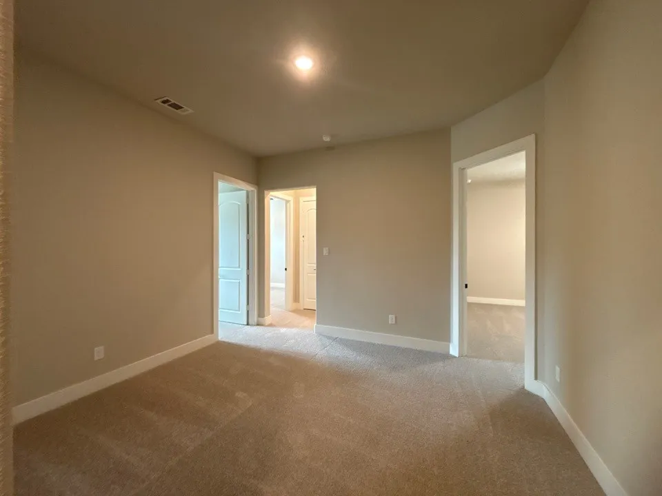 Plush carpet flooring with neutral paint tones, recessed lighting, and white trim