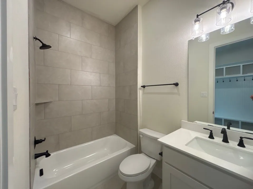 Bathtub with tiled surround and integrated shelf
