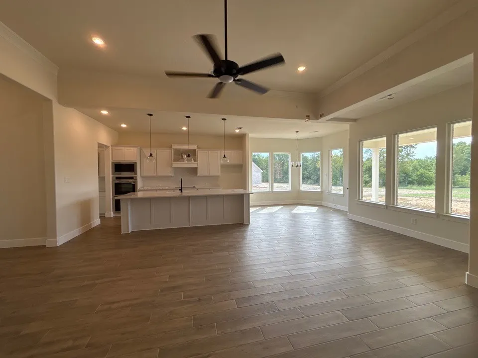 Open concept living space featuring wood-finish flooring, recessed lighting, and a ceiling fan