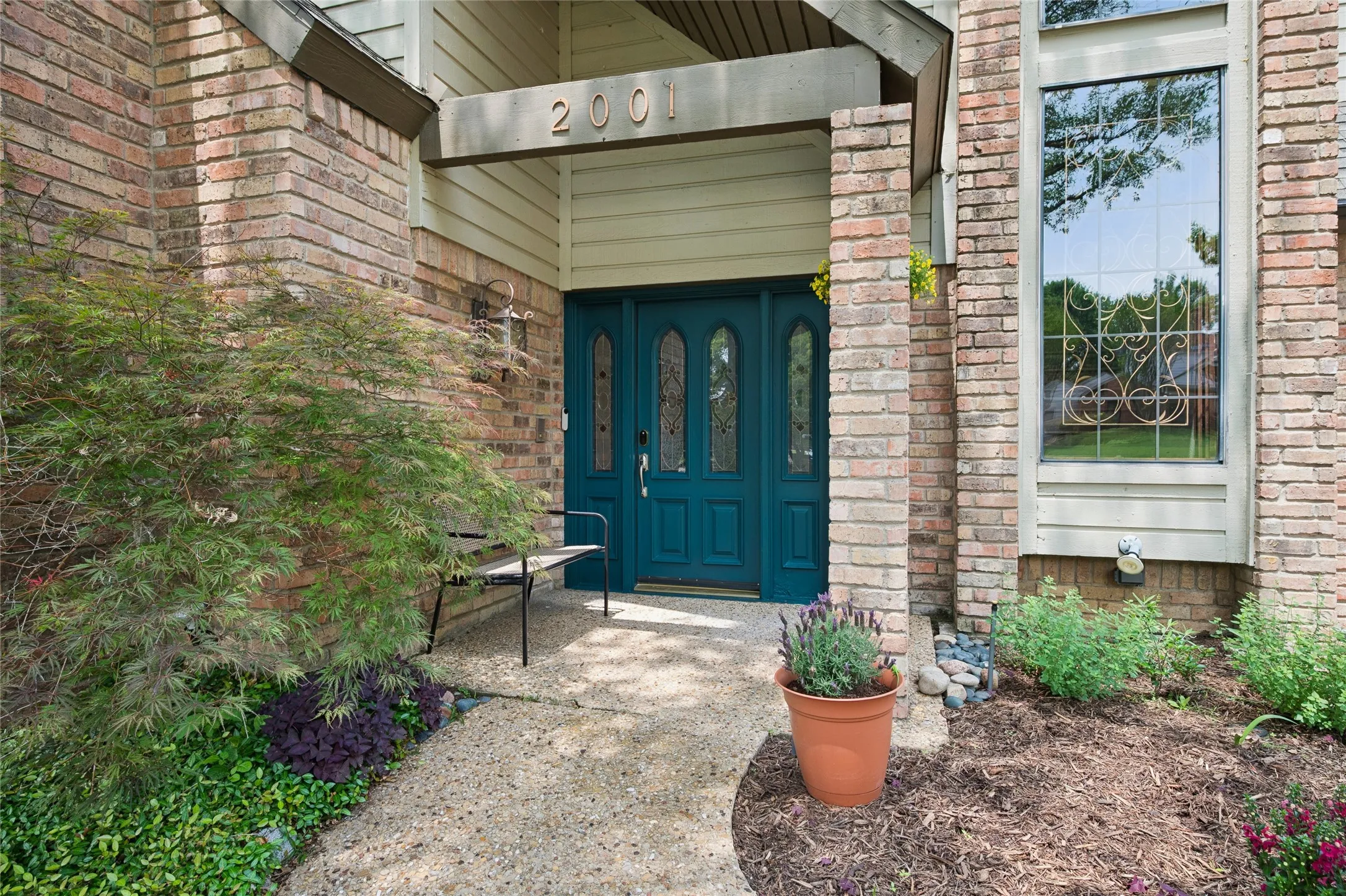 Beautiful forest teal front door brings a vibrant and welcoming look.