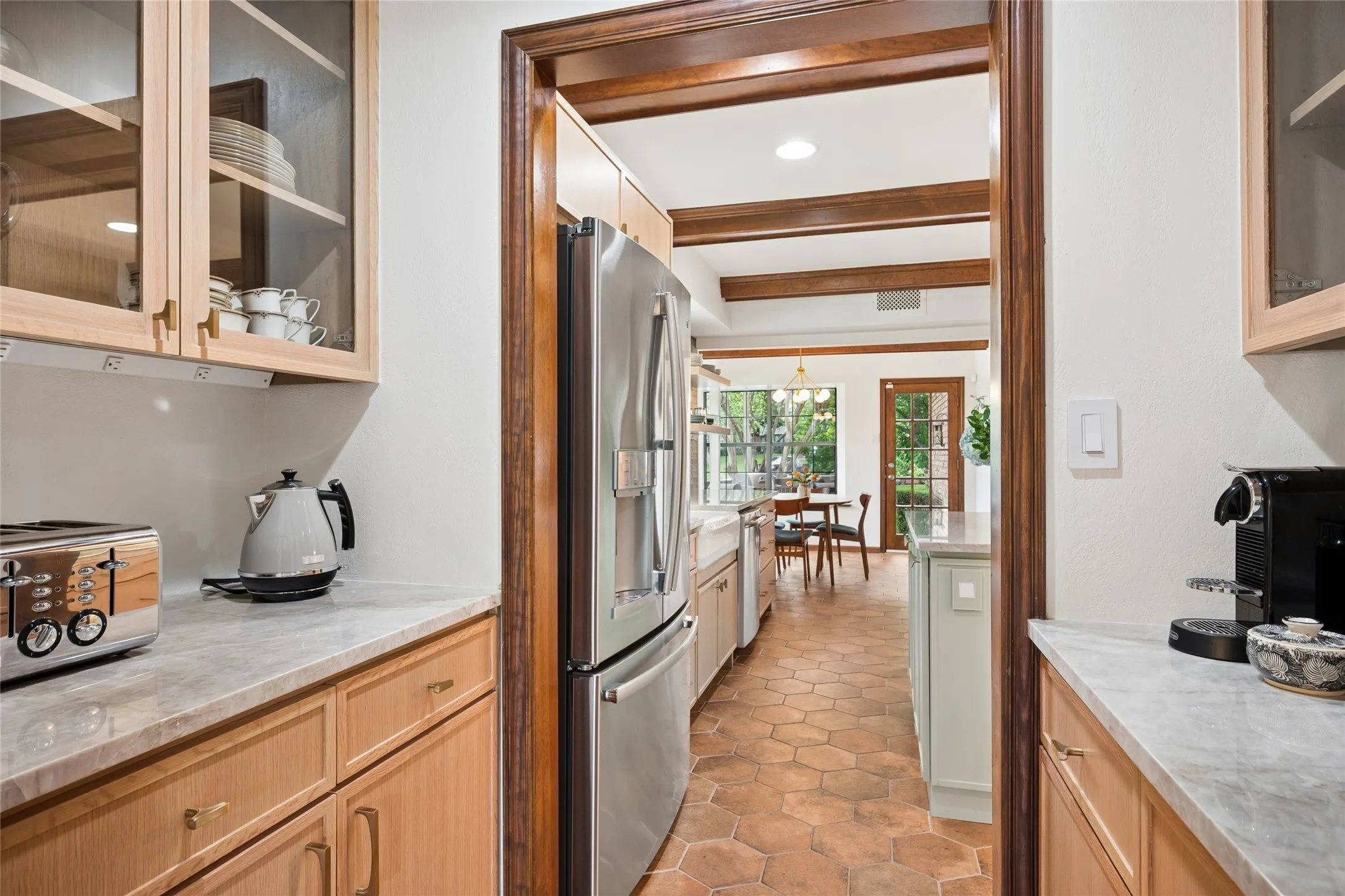 This butler's pantry adds beauty and function to the space with additional storage and direct access to the kitchen and dining area.