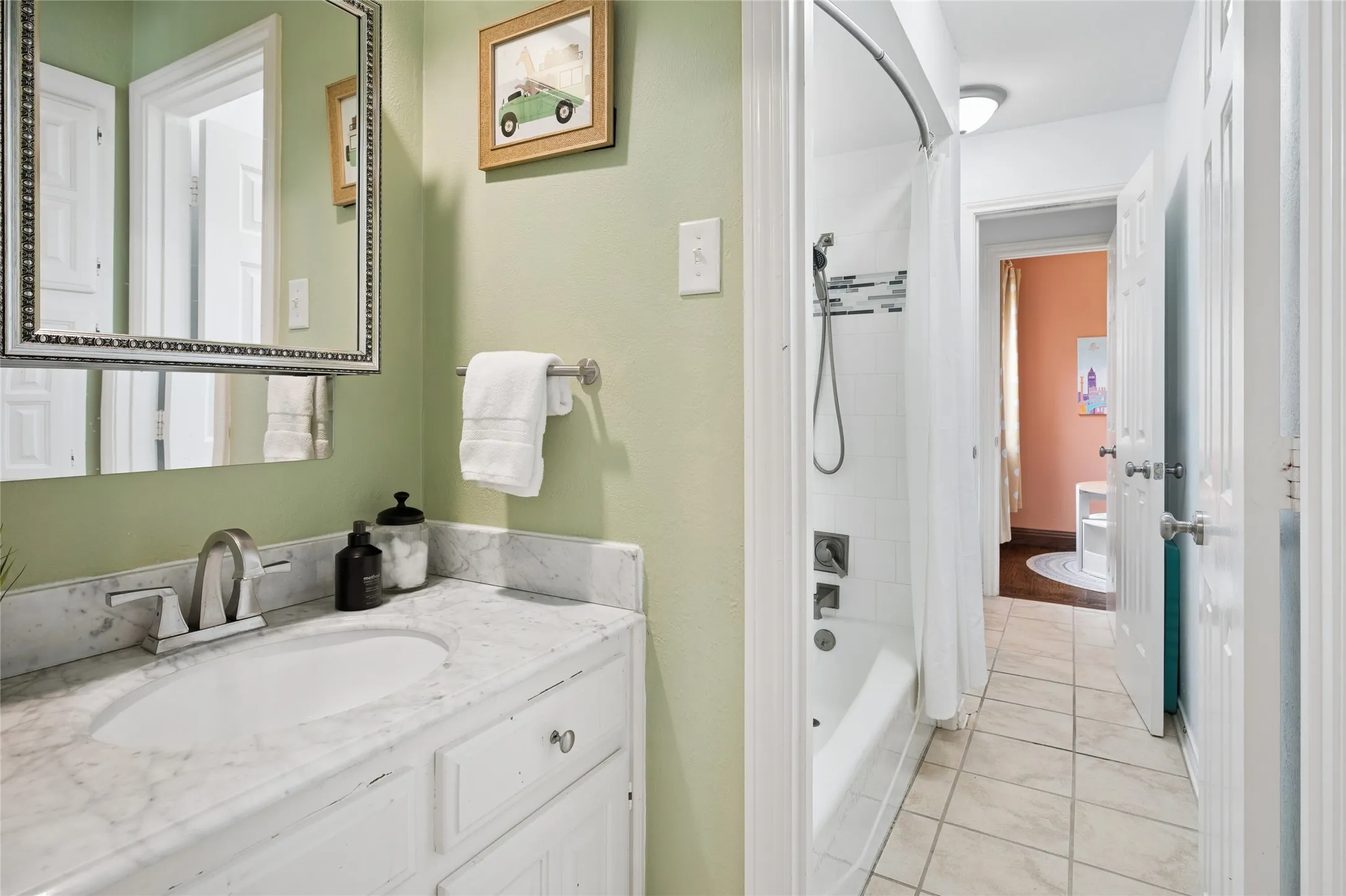 Plenty of space here in the Jack and Jill bathroom with updated Carrera Marble vanities.