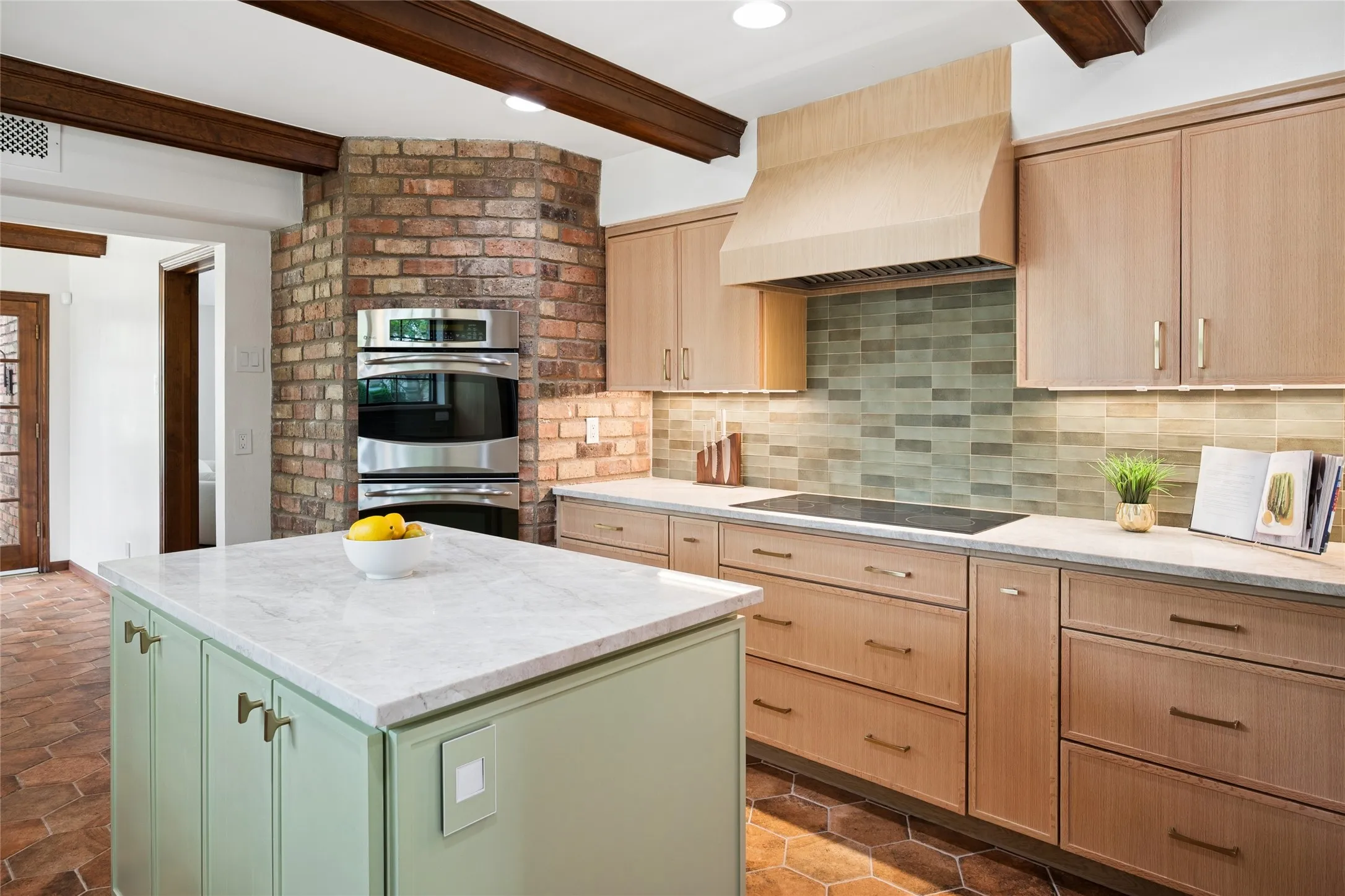 This culinary powerhouse is equipped with custom quartz counters, a double oven, under cab lighting and an induction cooktop.
