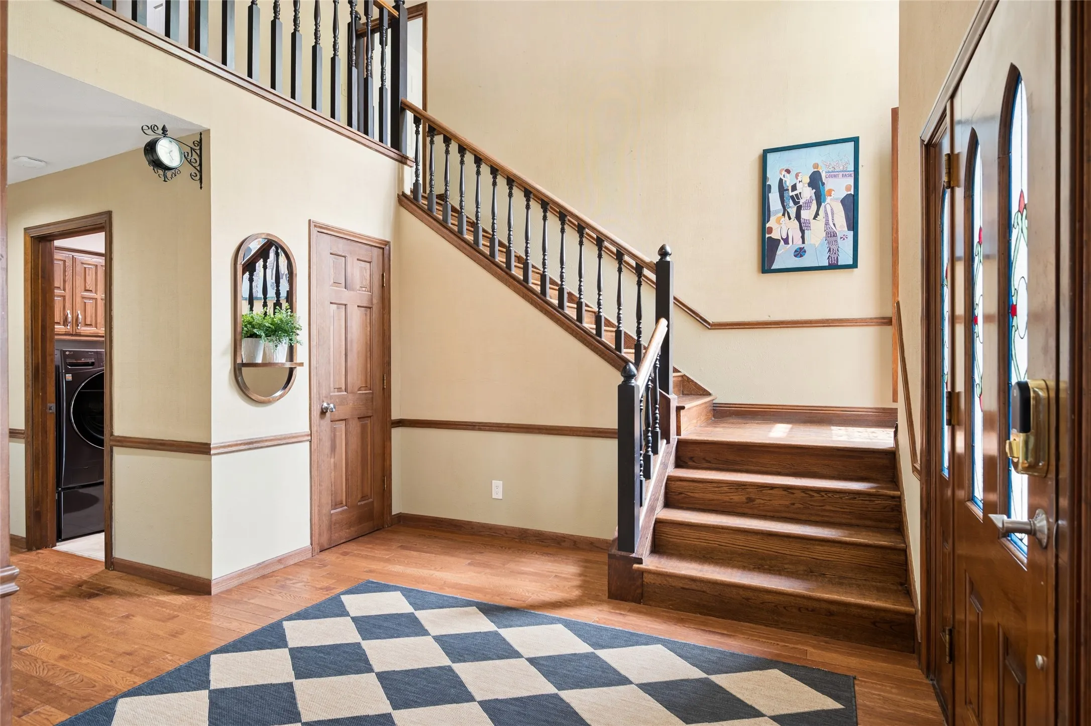 Rich hardwood floors and stairs along with soaring ceilings welcome you upon entry.