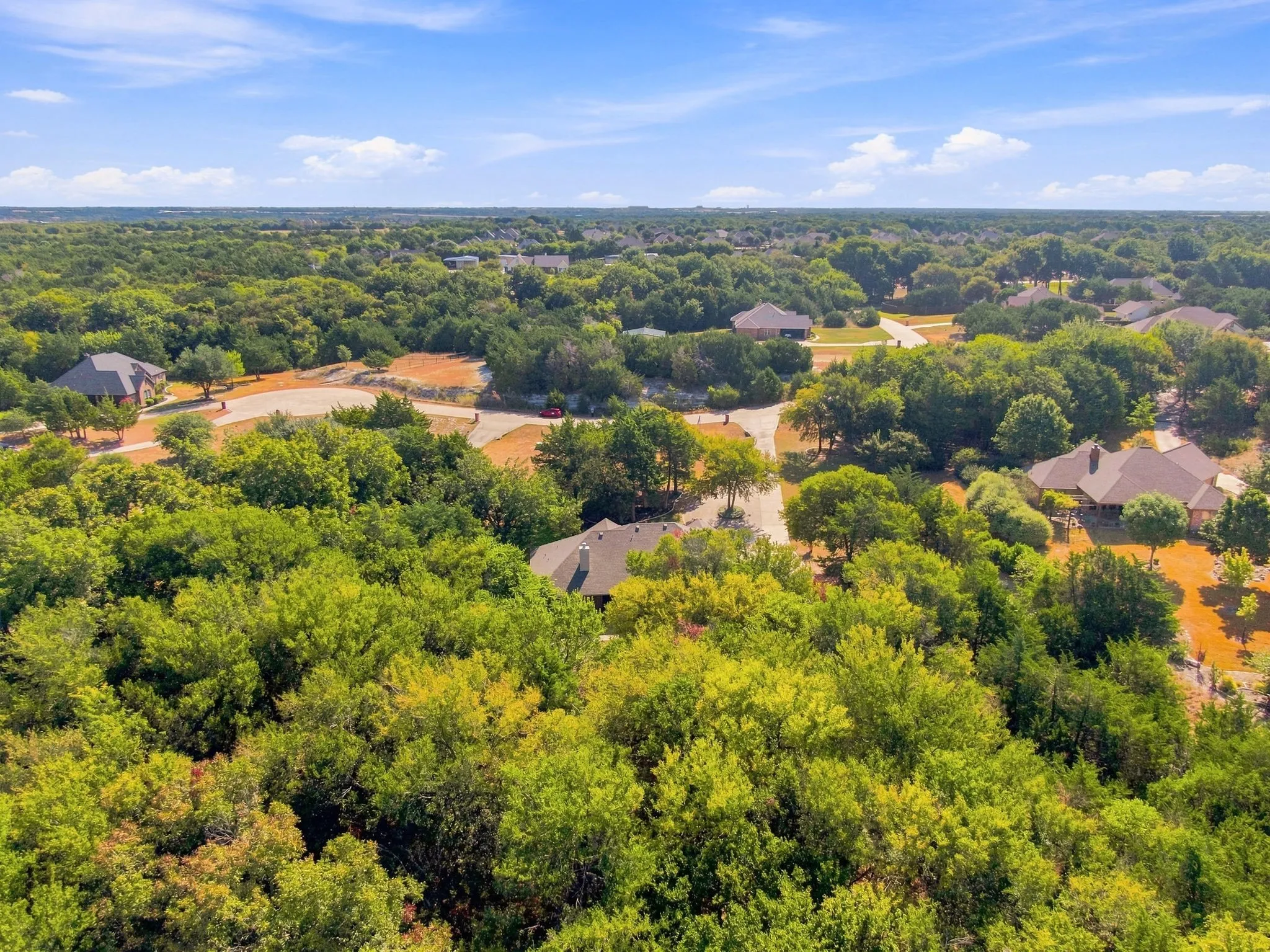 Another stunning aerial angle capturing the depth and privacy of this heavily wooded acreage.