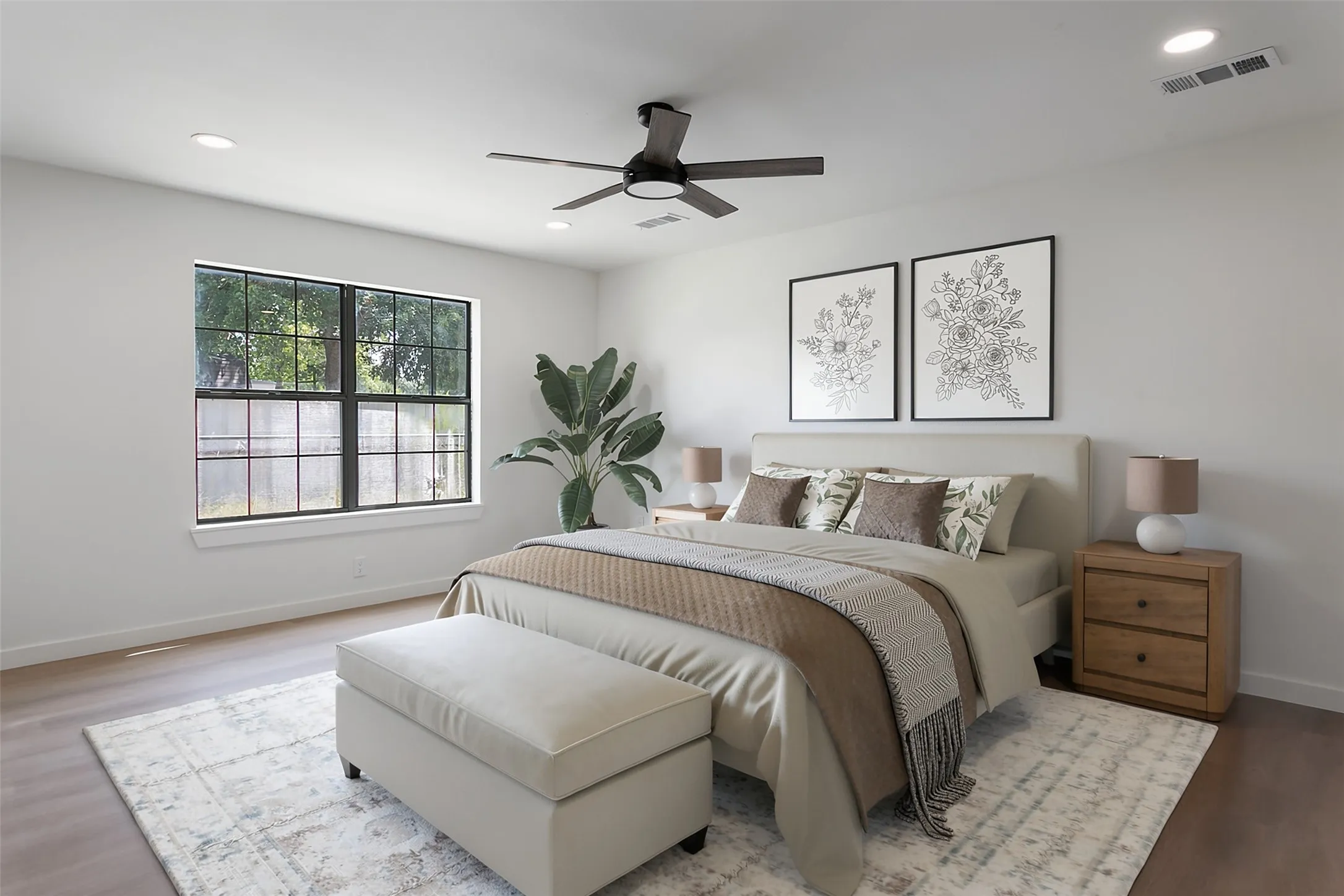 Recessed lighting, a dark-finish ceiling fan, and wood-finish flooring