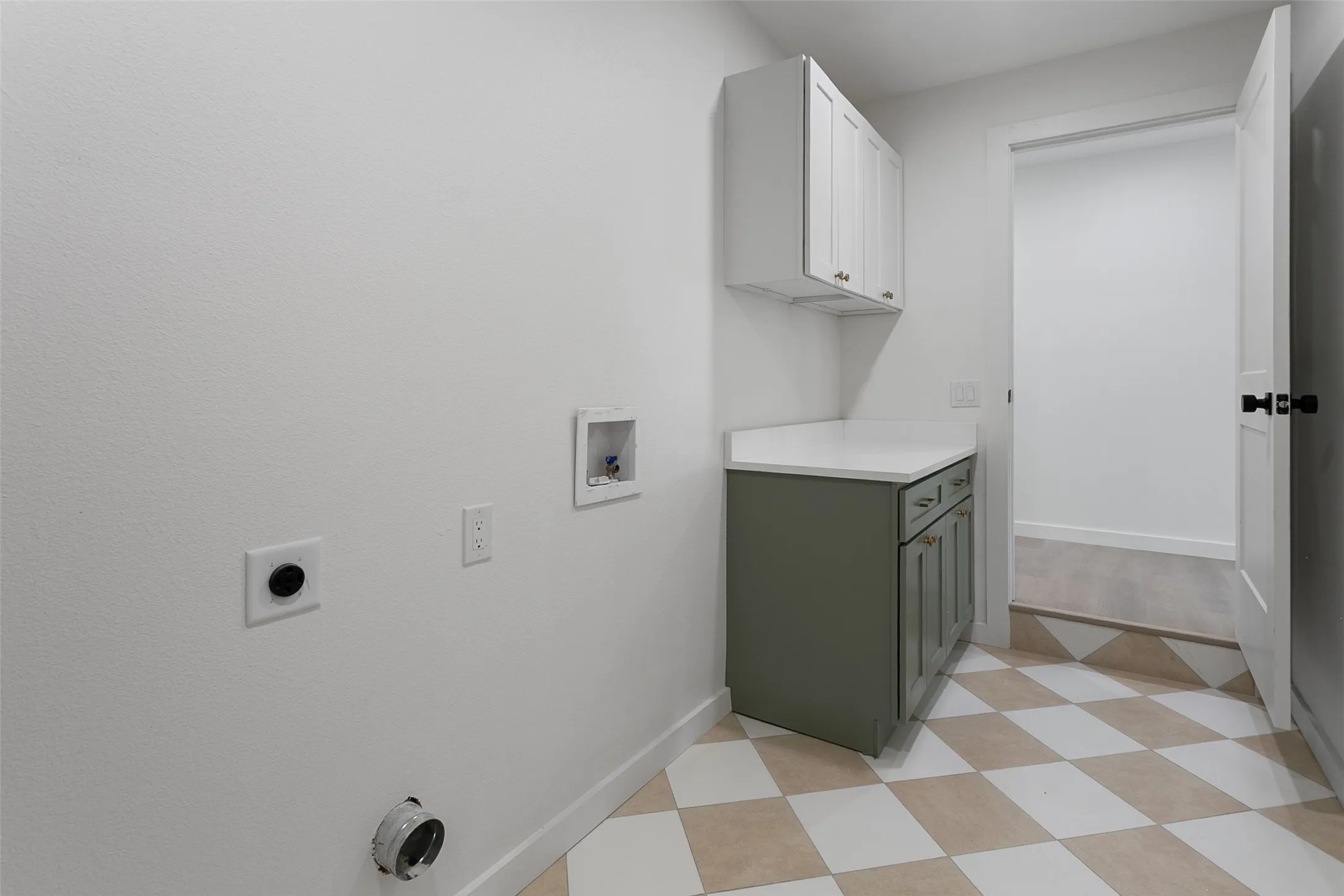 Checkerboard floor tiling, upper white cabinetry, lower green cabinetry, white countertop