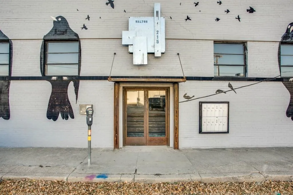 White brick exterior with prominent artistic mural