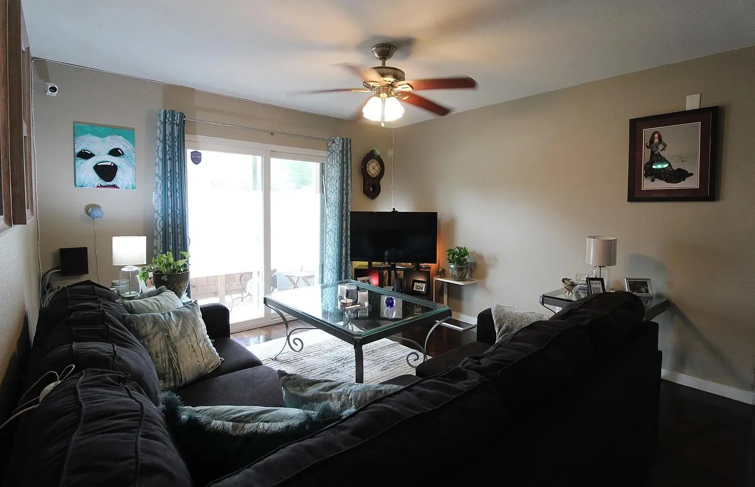 Sliding glass door, ceiling fan with light fixture, recessed ceiling, dark wood-finish flooring, and neutral wall paint