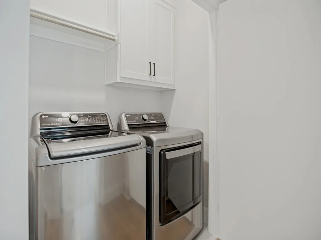 full size laundry area in hallway between bedrooms