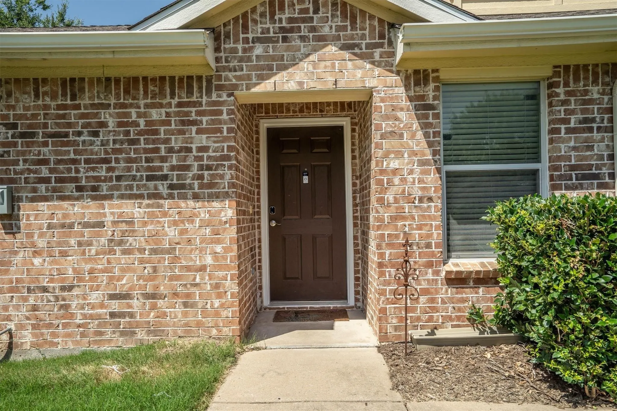 Brick exterior facade with a covered entry