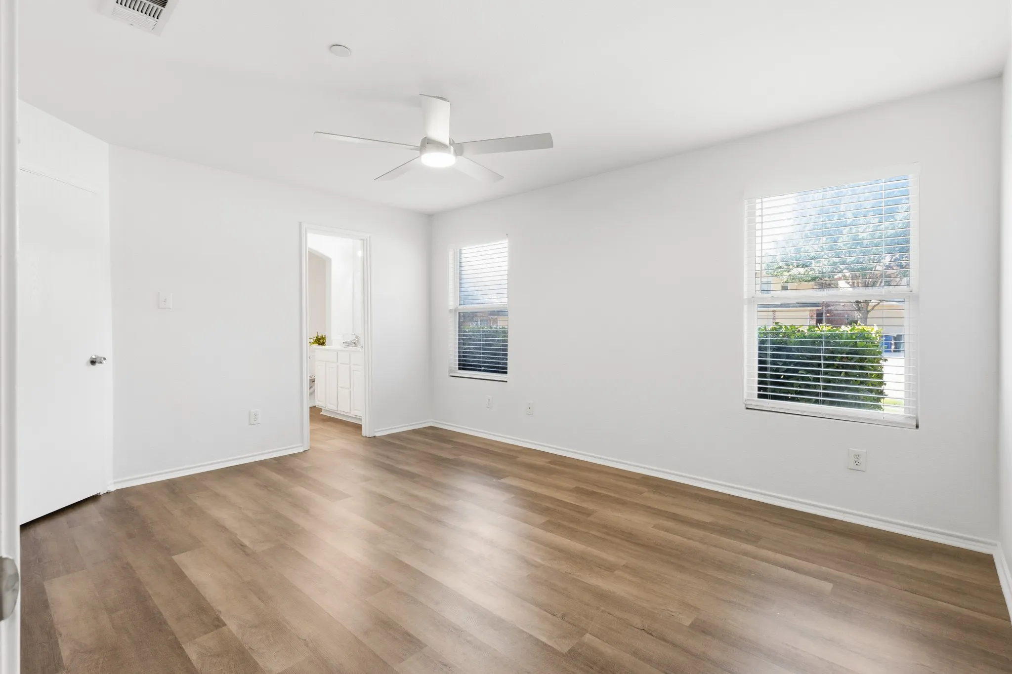 Recessed lighting, wood-finish flooring, ceiling fan, and white window blinds