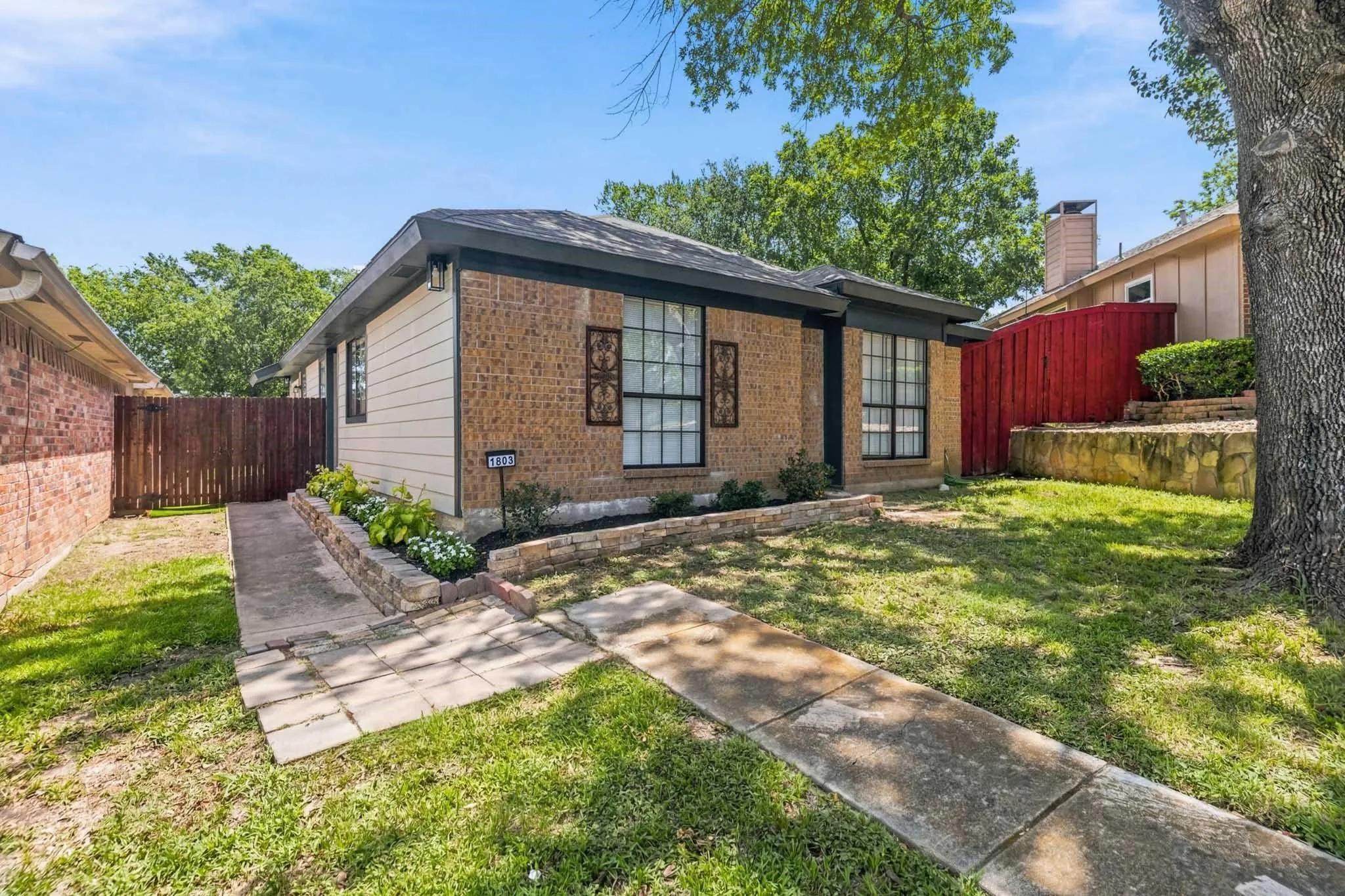 Brick and siding exterior with a dark shingle roof