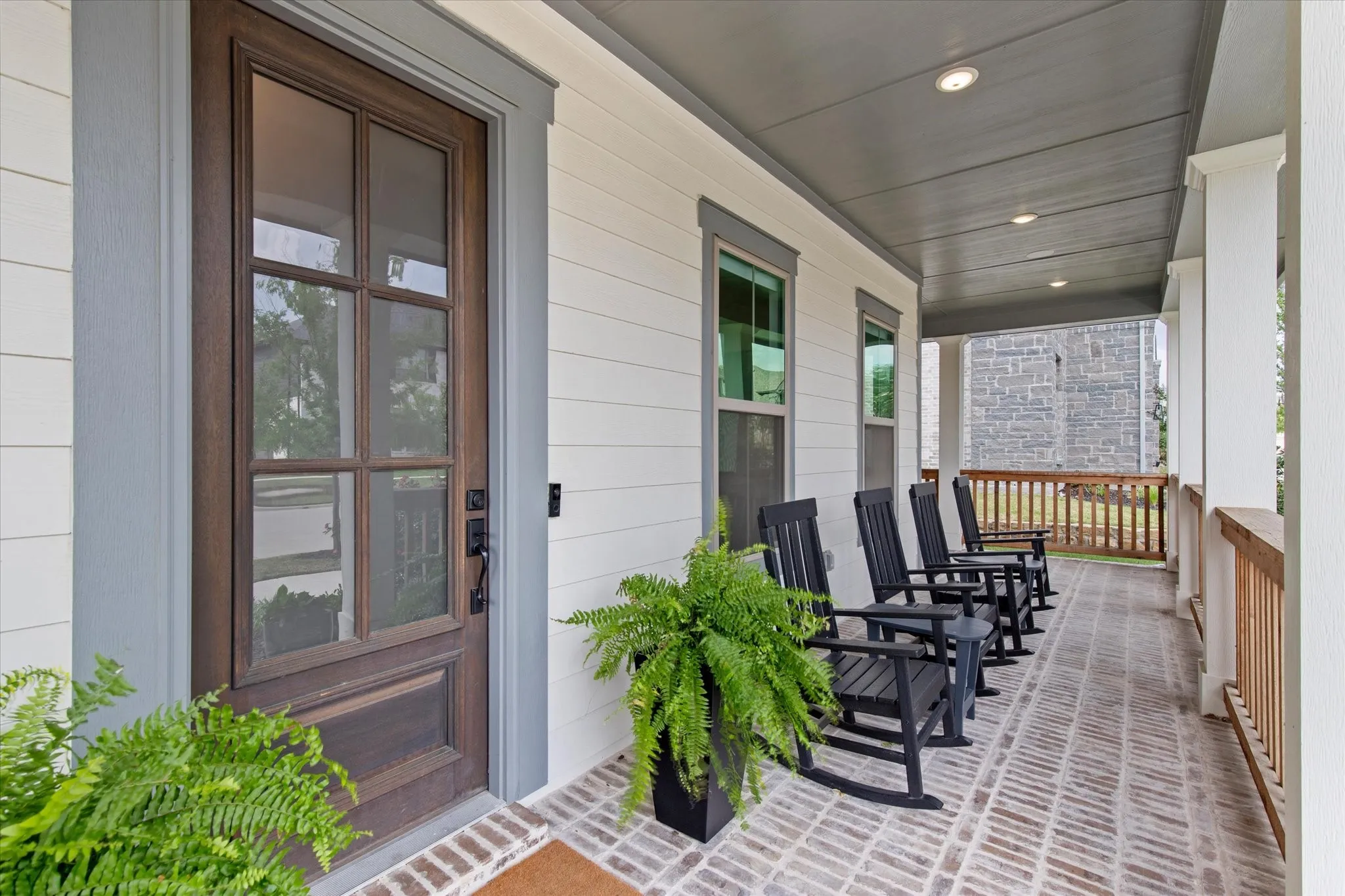 Front brick patio that wraps around to the right.