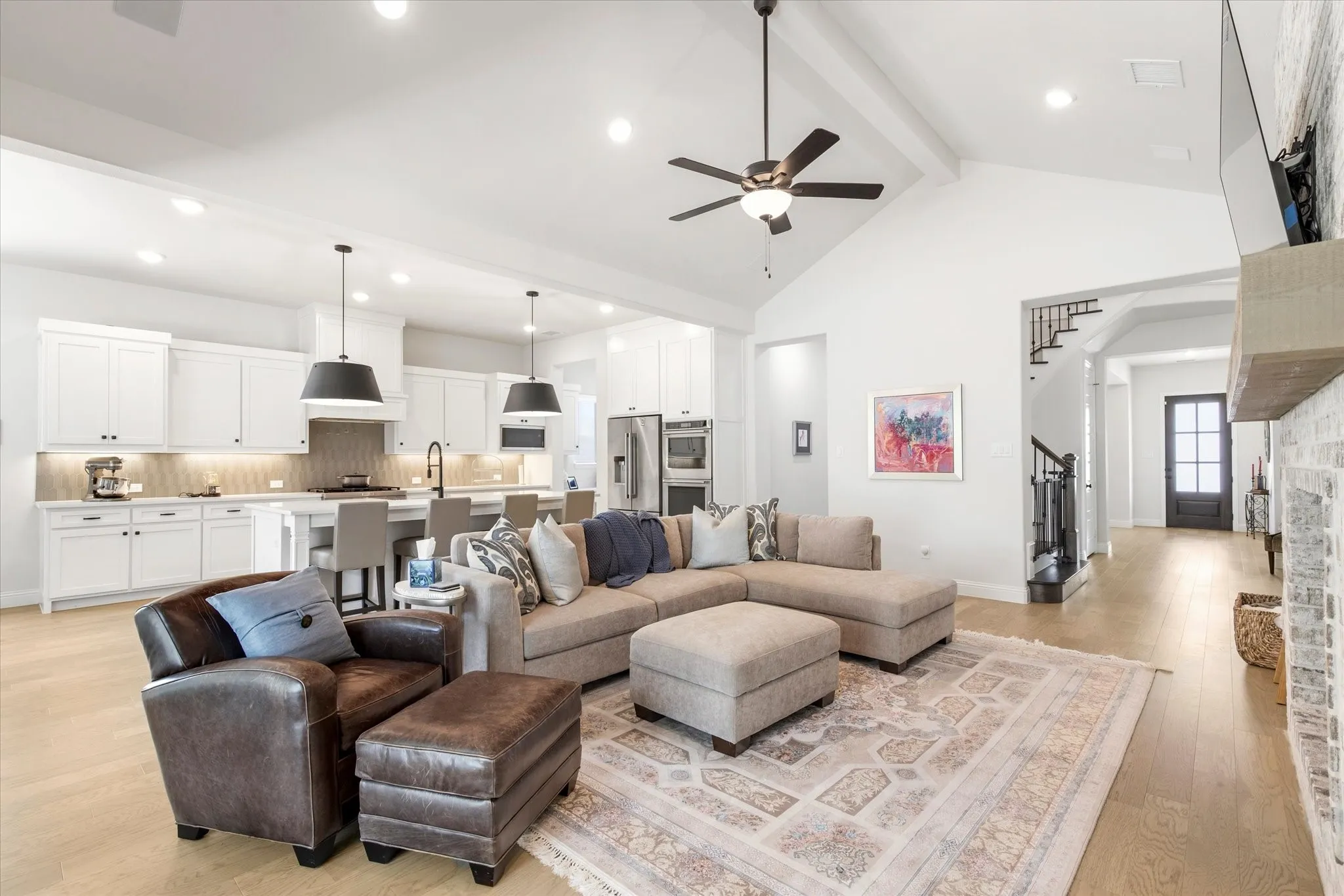 Living Area opens into the Kitchen, making this home feel super cozy with vaulted ceilings, fireplace and updated lighting.