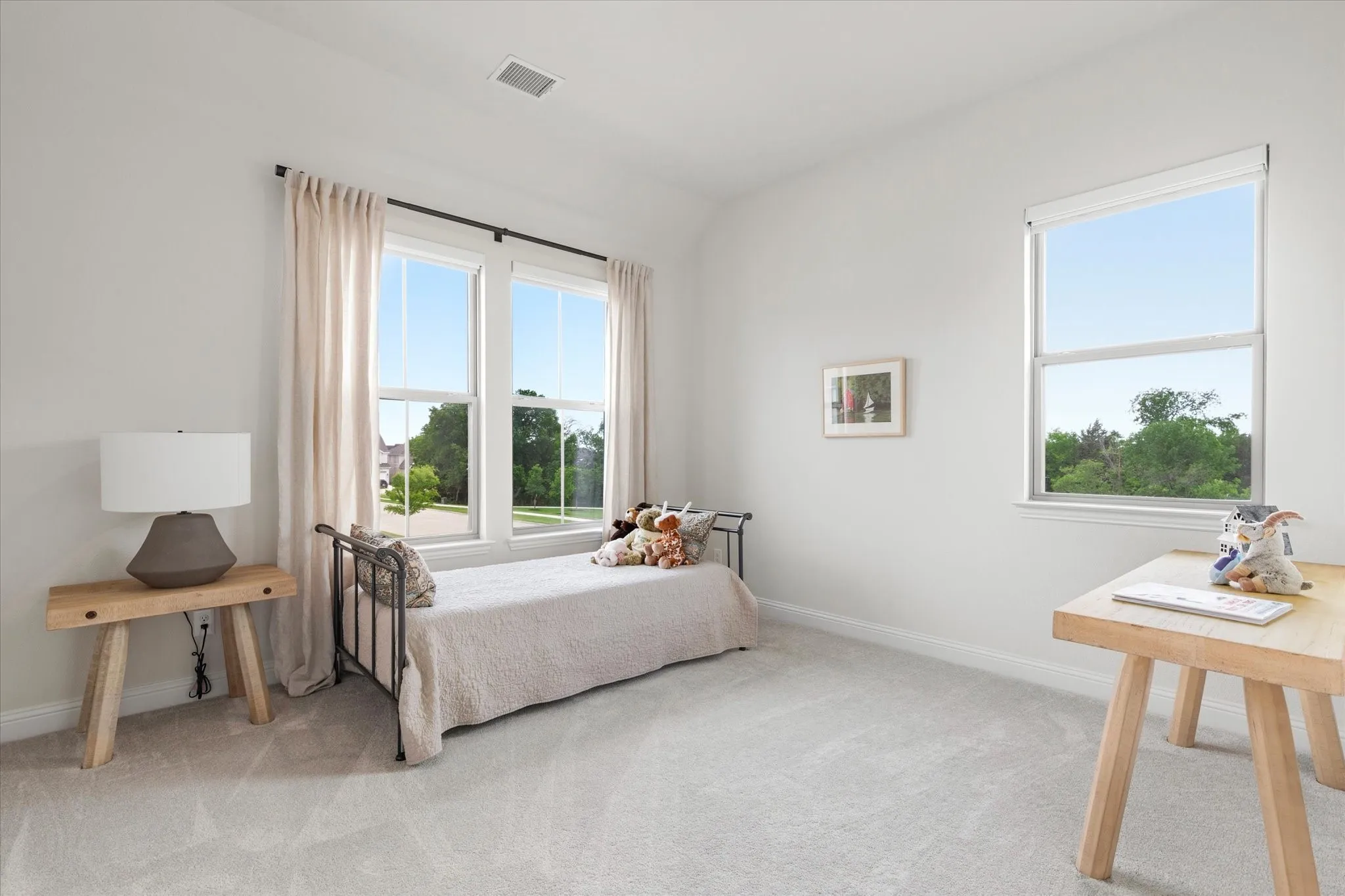 Second floor bedroom with lots of windows that let in tons of natural light.